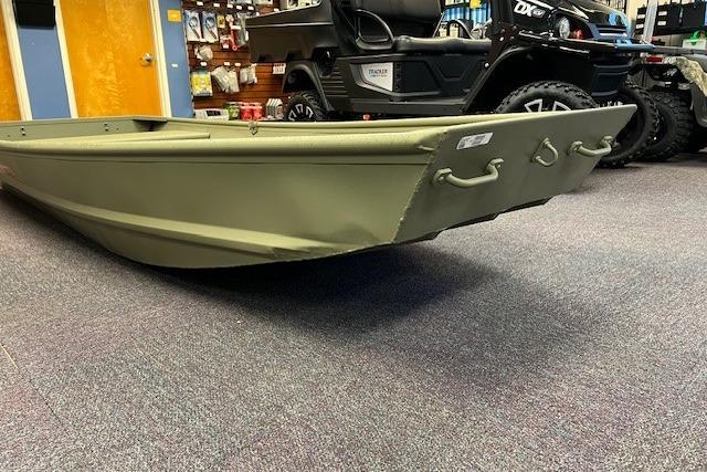 2026 Tracker Grizzly 12 Jon boat displayed in a showroom with accessories.