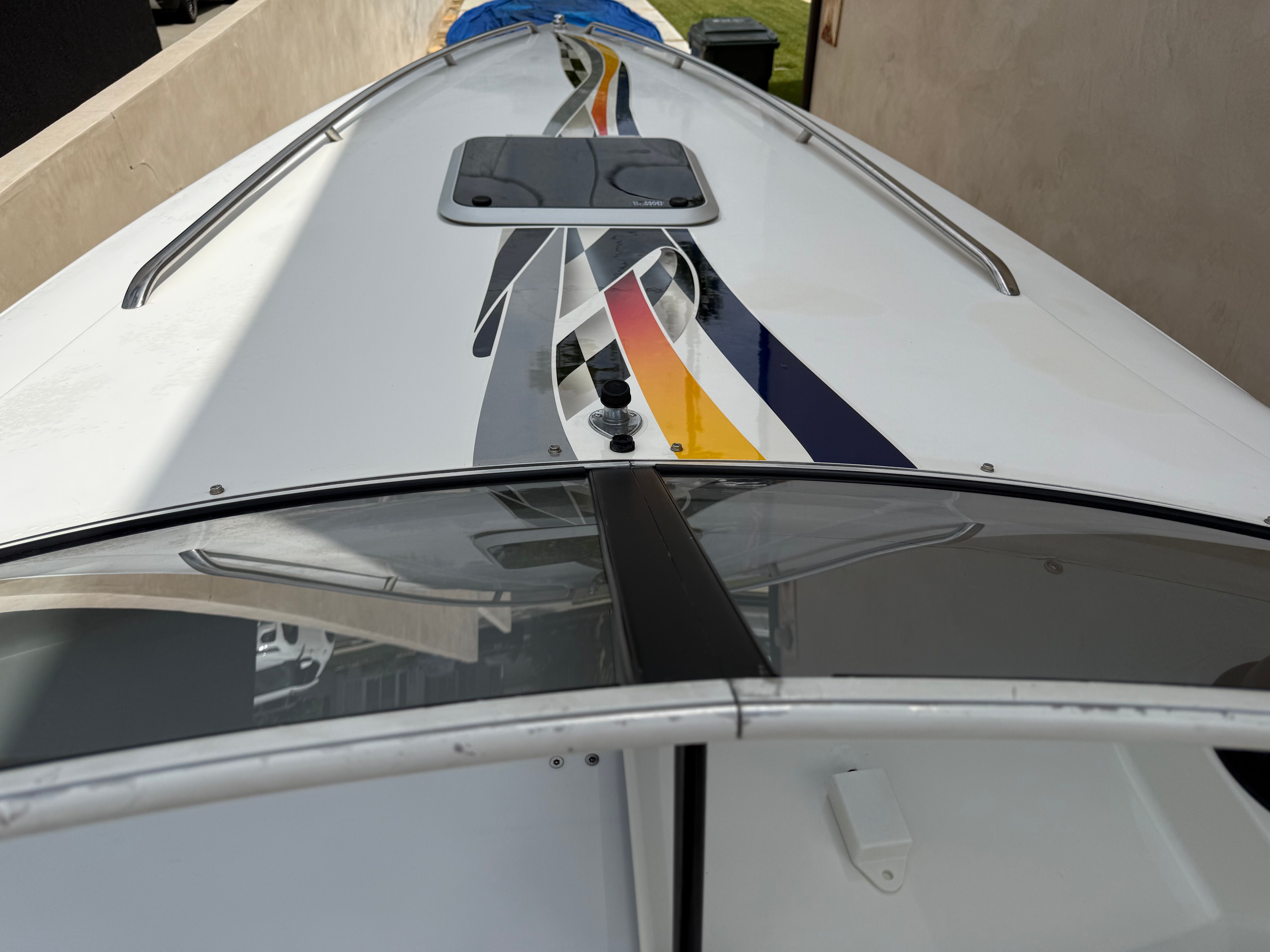 Wellcraft 29 Scarab 2001 boat with colorful stripe design.