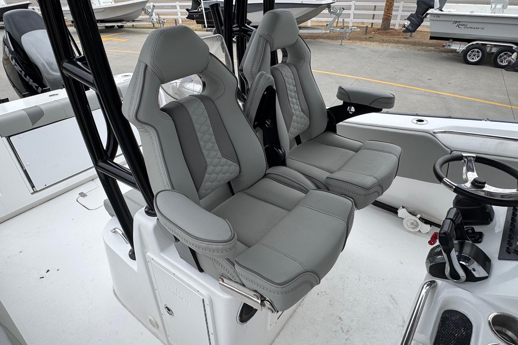 2024 Cape Horn 32 XS boat interior with dual gray captain seats and steering wheel.