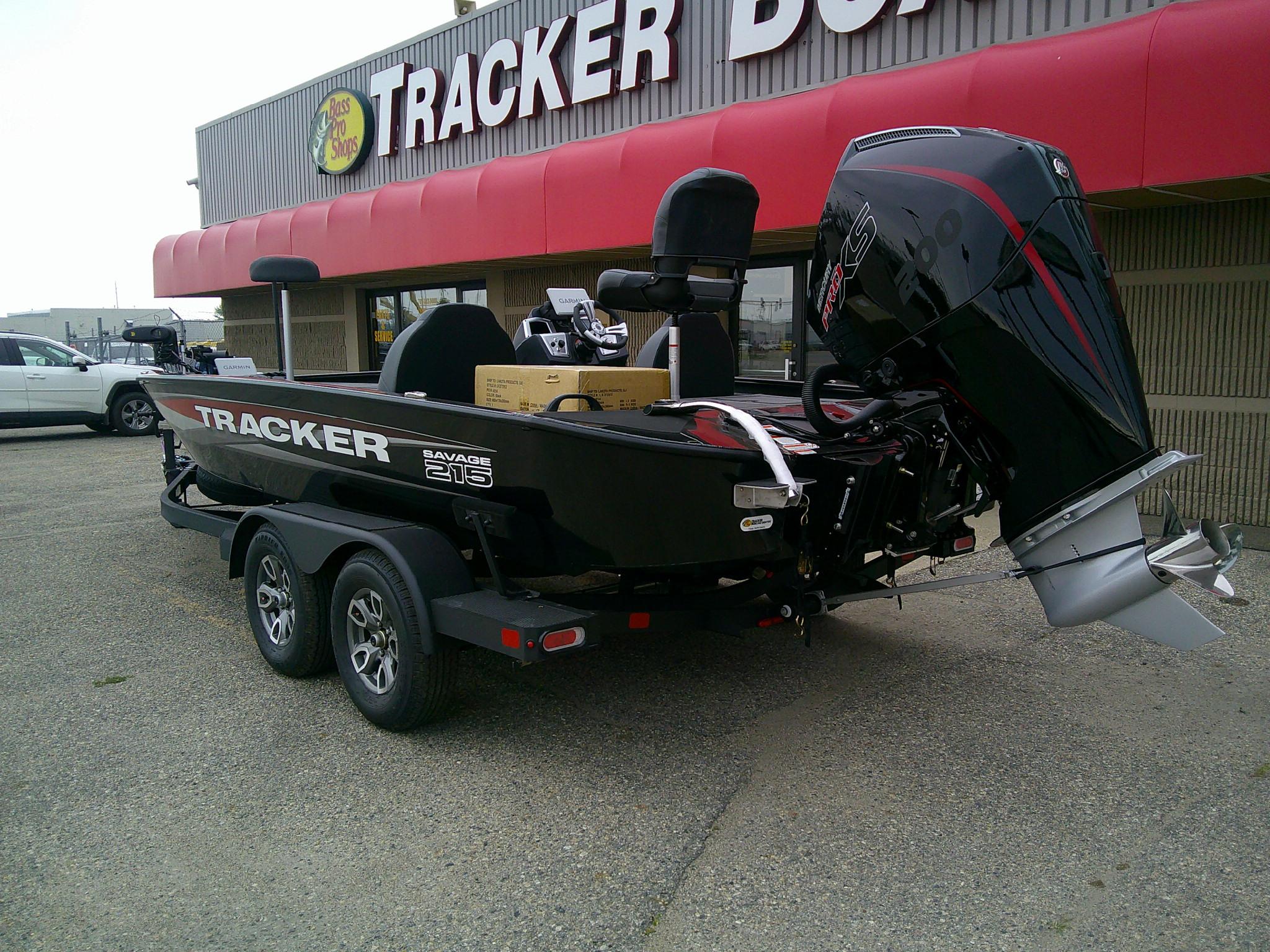 2025 Tracker Savage 215 boat parked outside Bass Pro Shops.