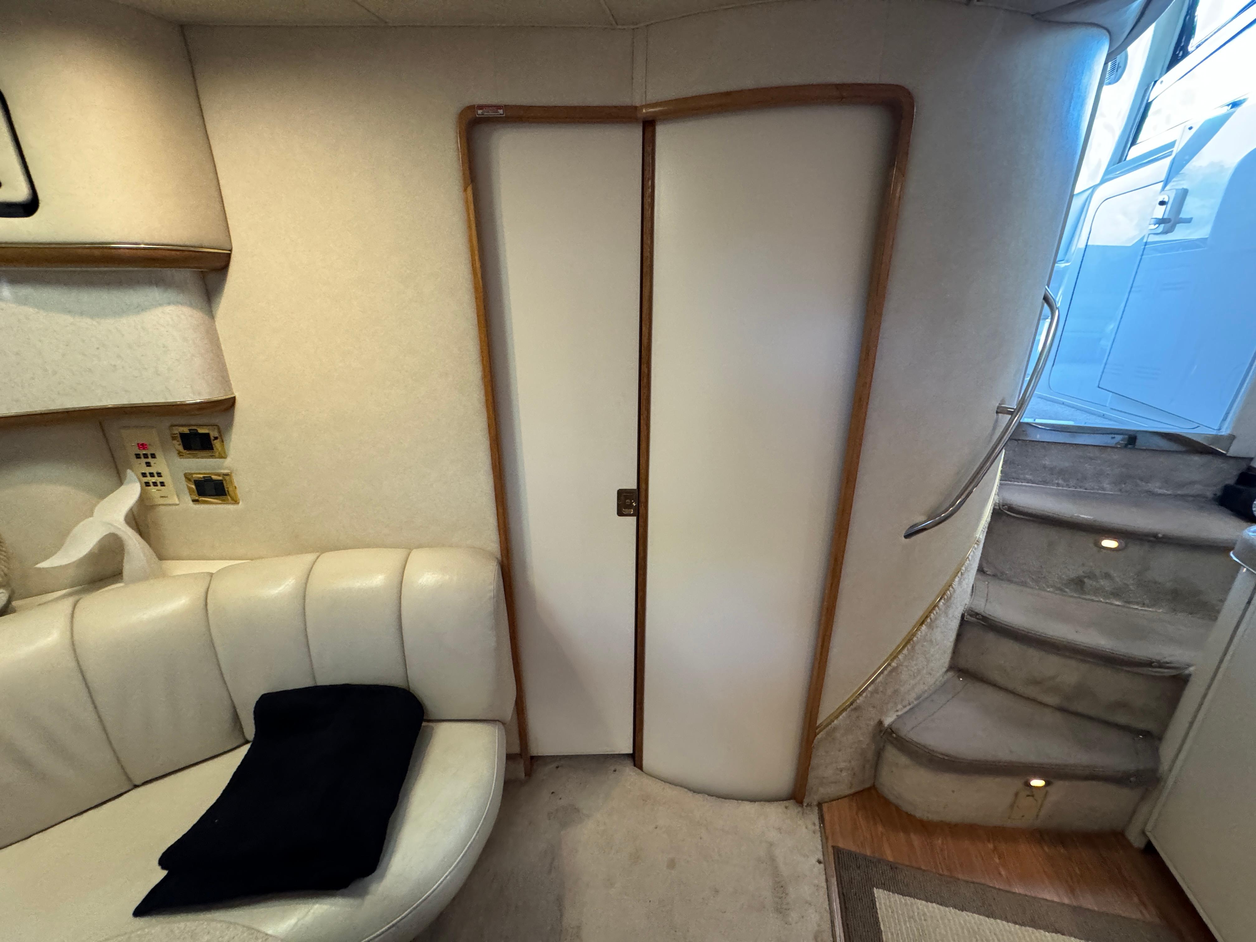 Interior of 1997 Sea Ray 450 Sundancer with stairs and seating area.