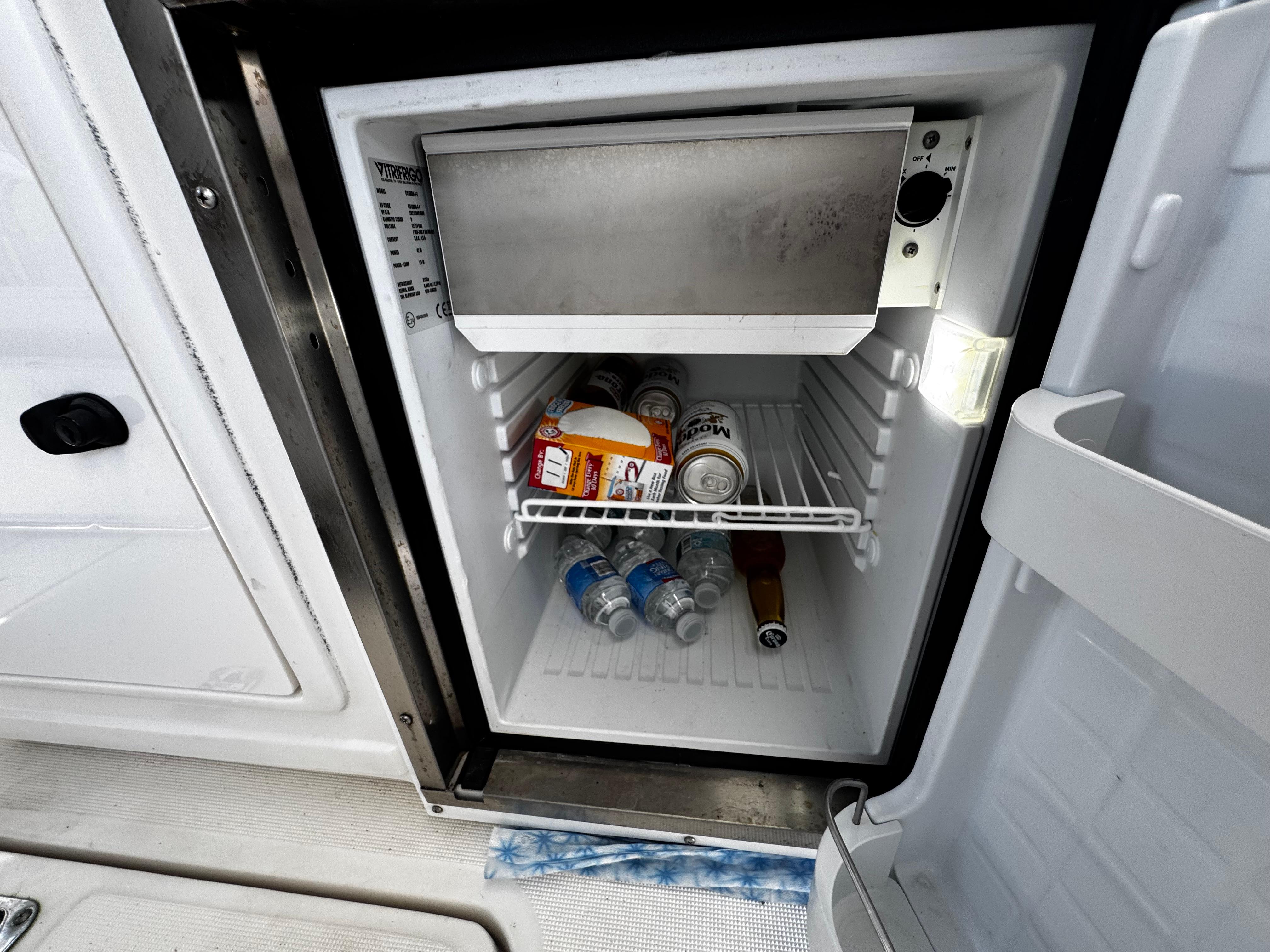 Mini fridge on 2000 Tiara Yachts 3500 Open, stocked with drinks and snacks.
