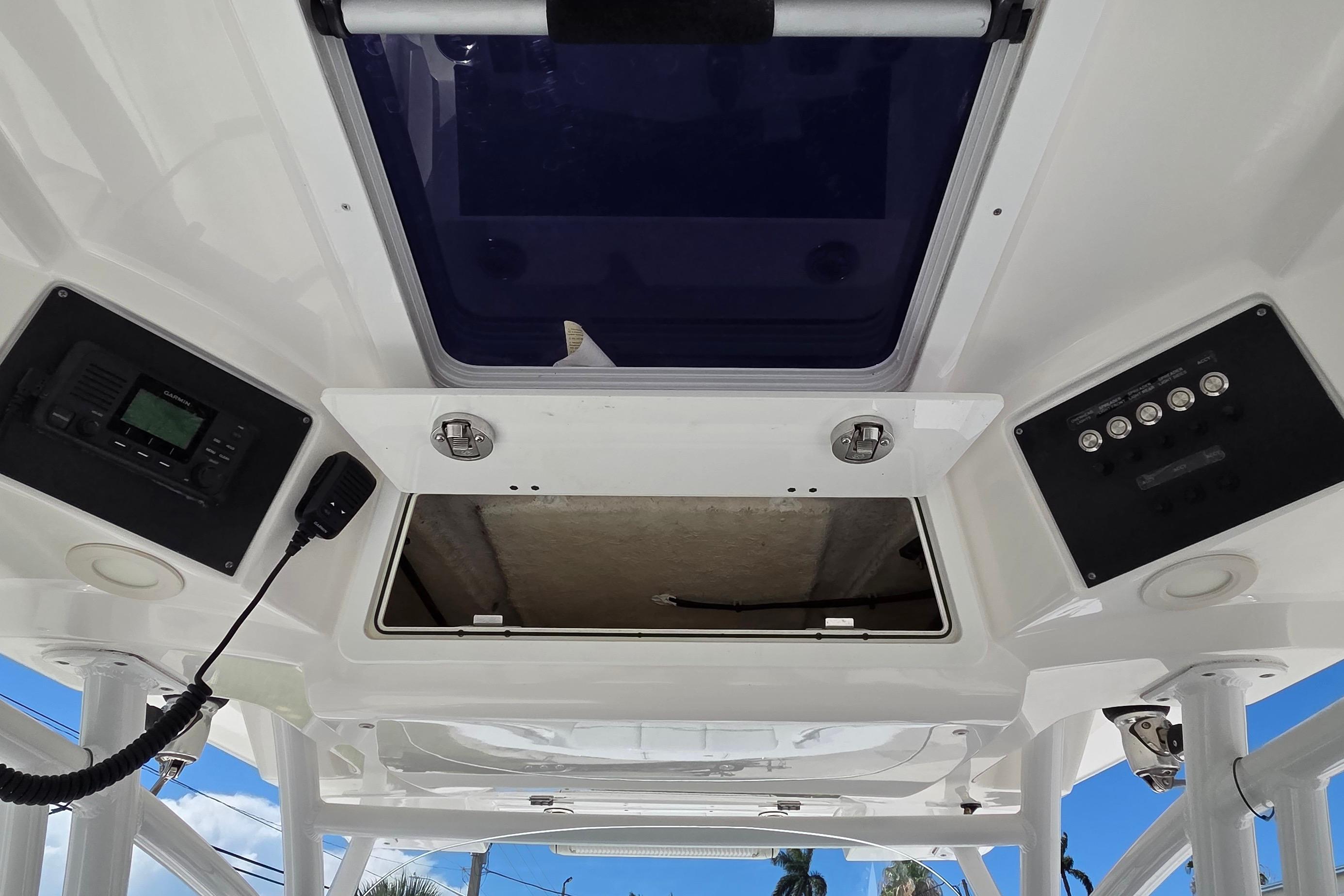 2021 Sea Fox 328 Commander boat console with open hatch and control panels.