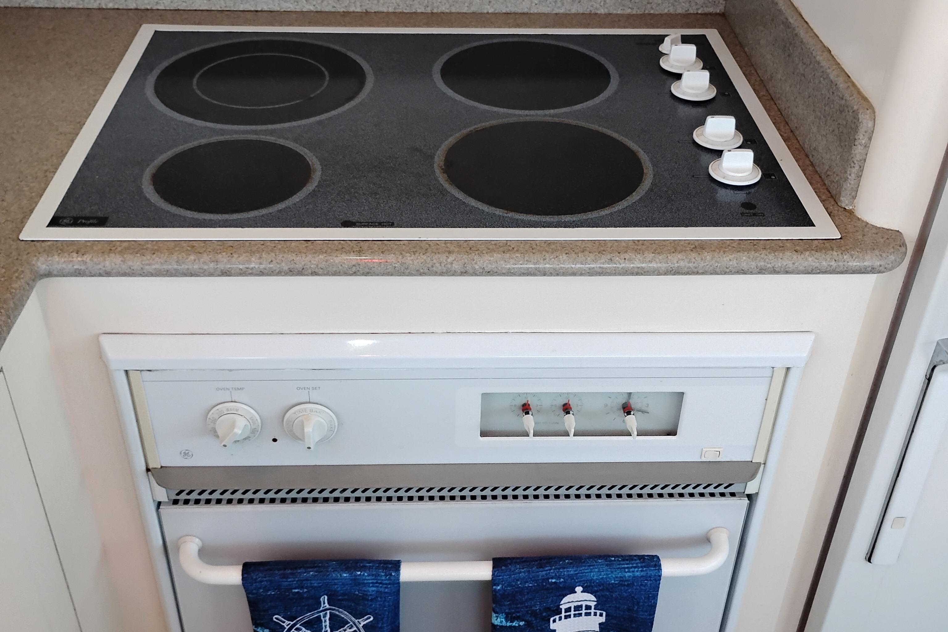 Stovetop and oven in 1995 Queenship 62 Pilothouse Motor Yacht kitchen.