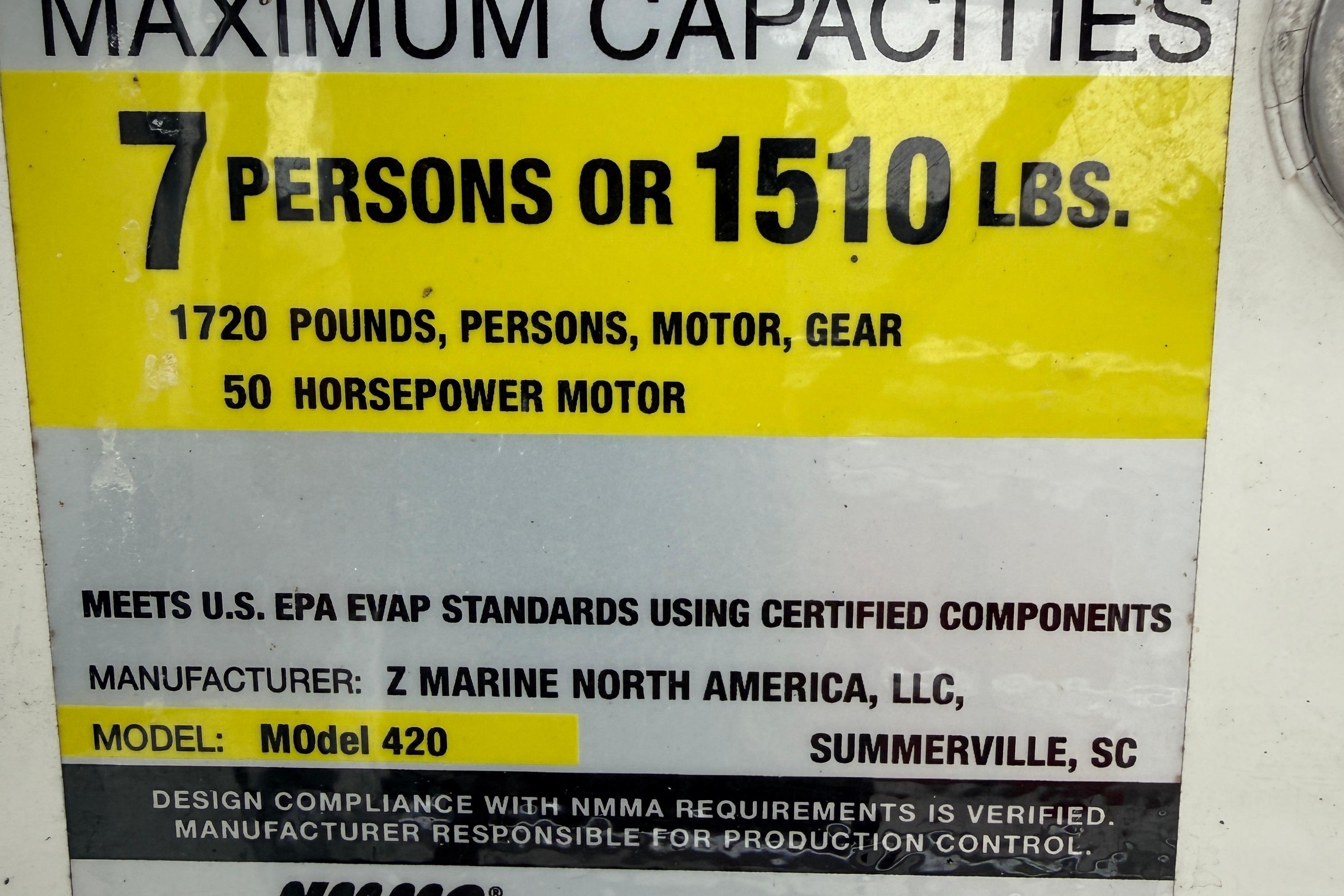 Zodiac Pro Classic 420 capacity label, 7 persons or 1510 lbs, 50 horsepower motor.