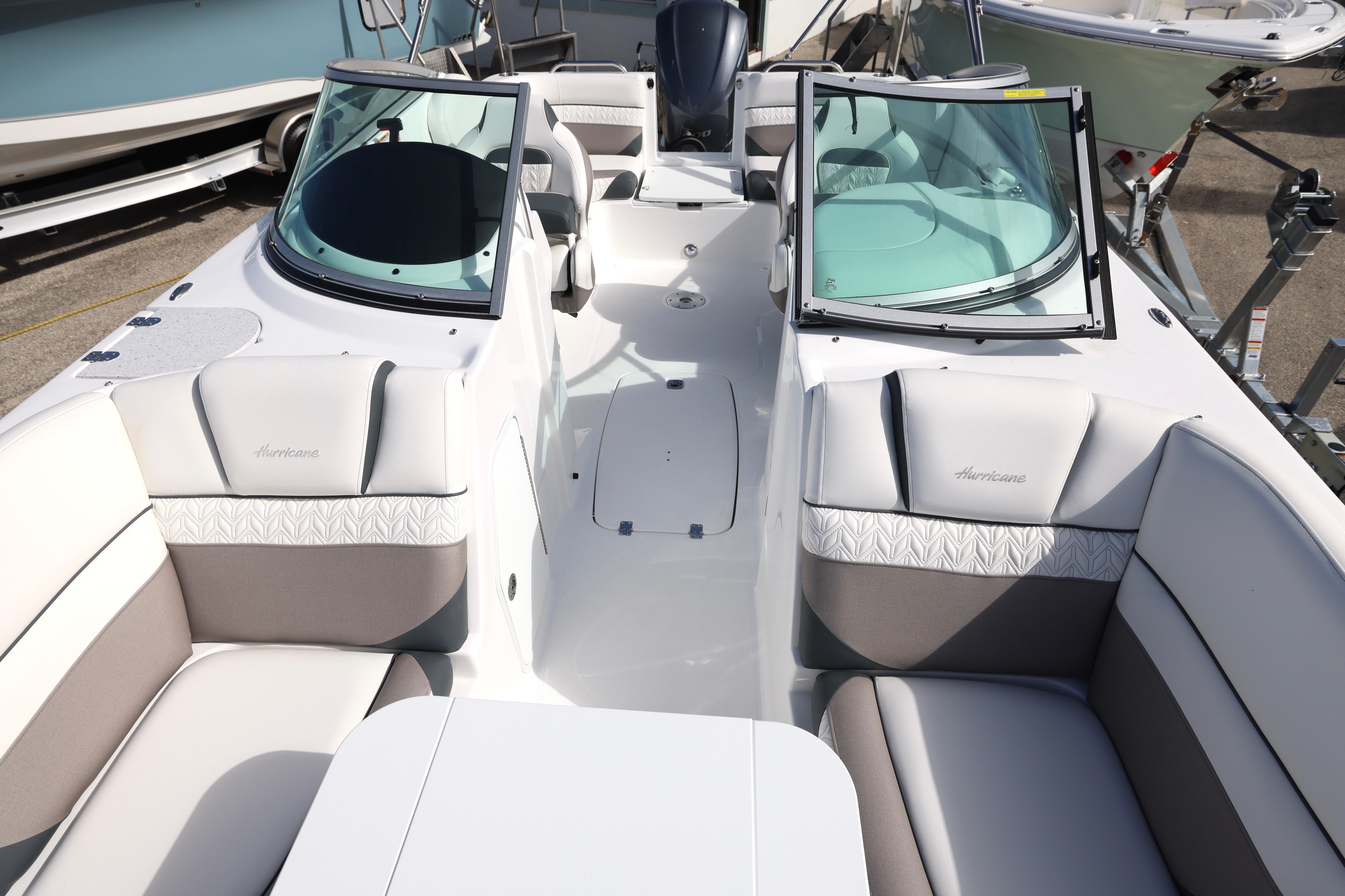 2026 Hurricane SunDeck 2486 OB boat interior with plush seating and dual windshields.