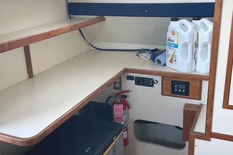 Interior of a 1997 Rosborough Trawler with shelves, fire extinguisher, and cleaning supplies.