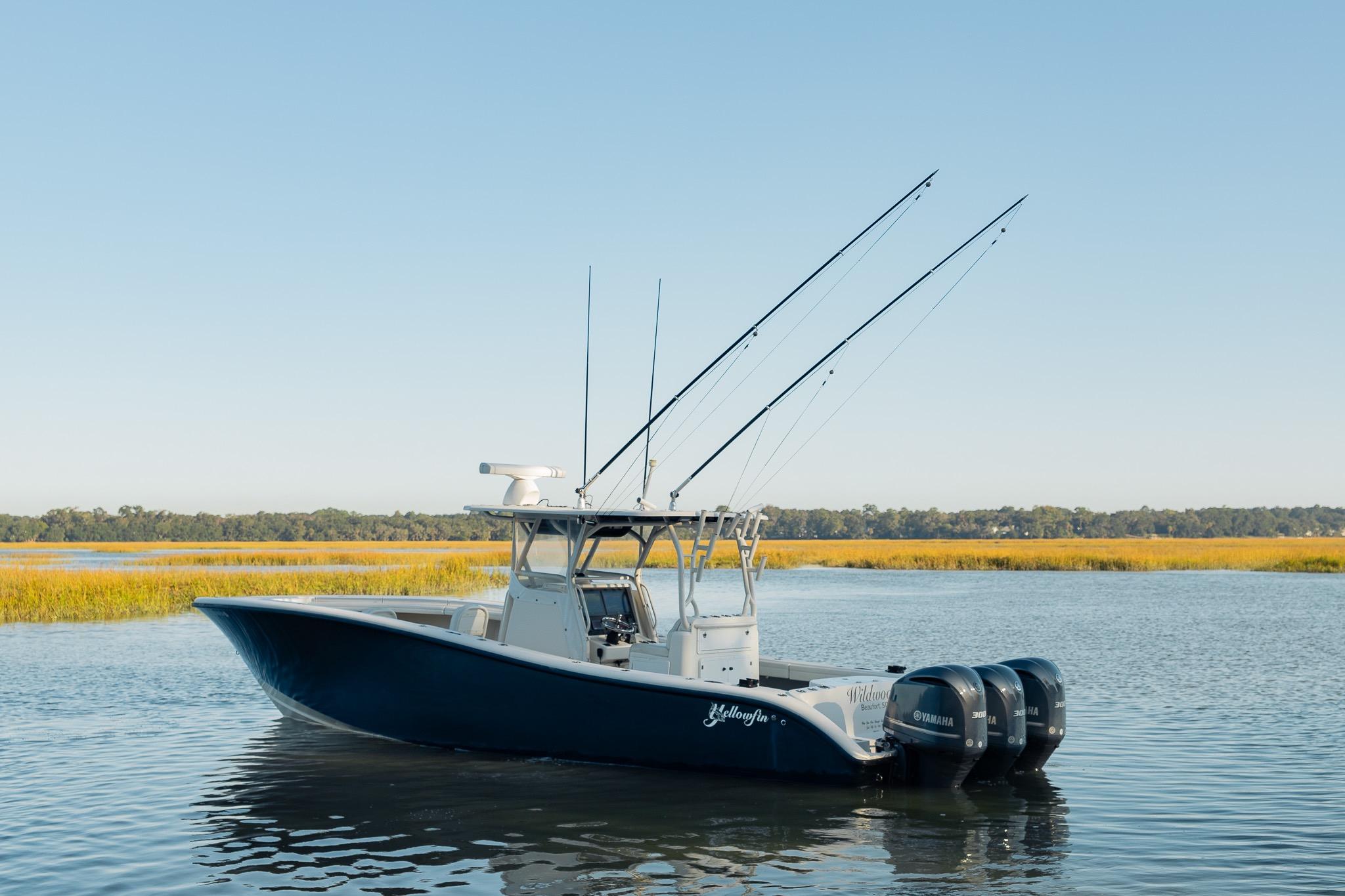 2014 Yellowfin 34 Offshore boat with triple Yamaha engines on calm water.