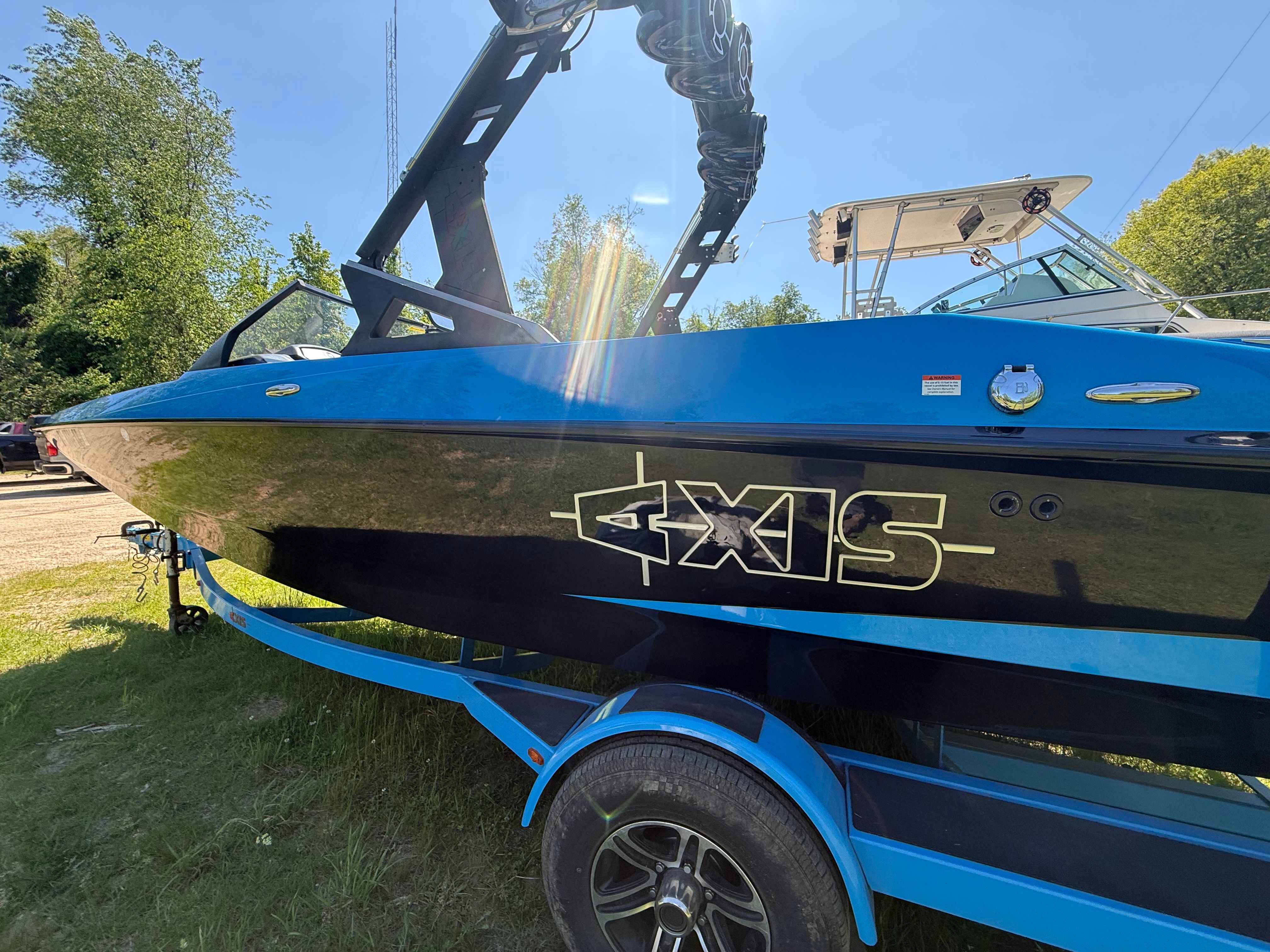 2015 Malibu Axis A20 boat on trailer outdoors.