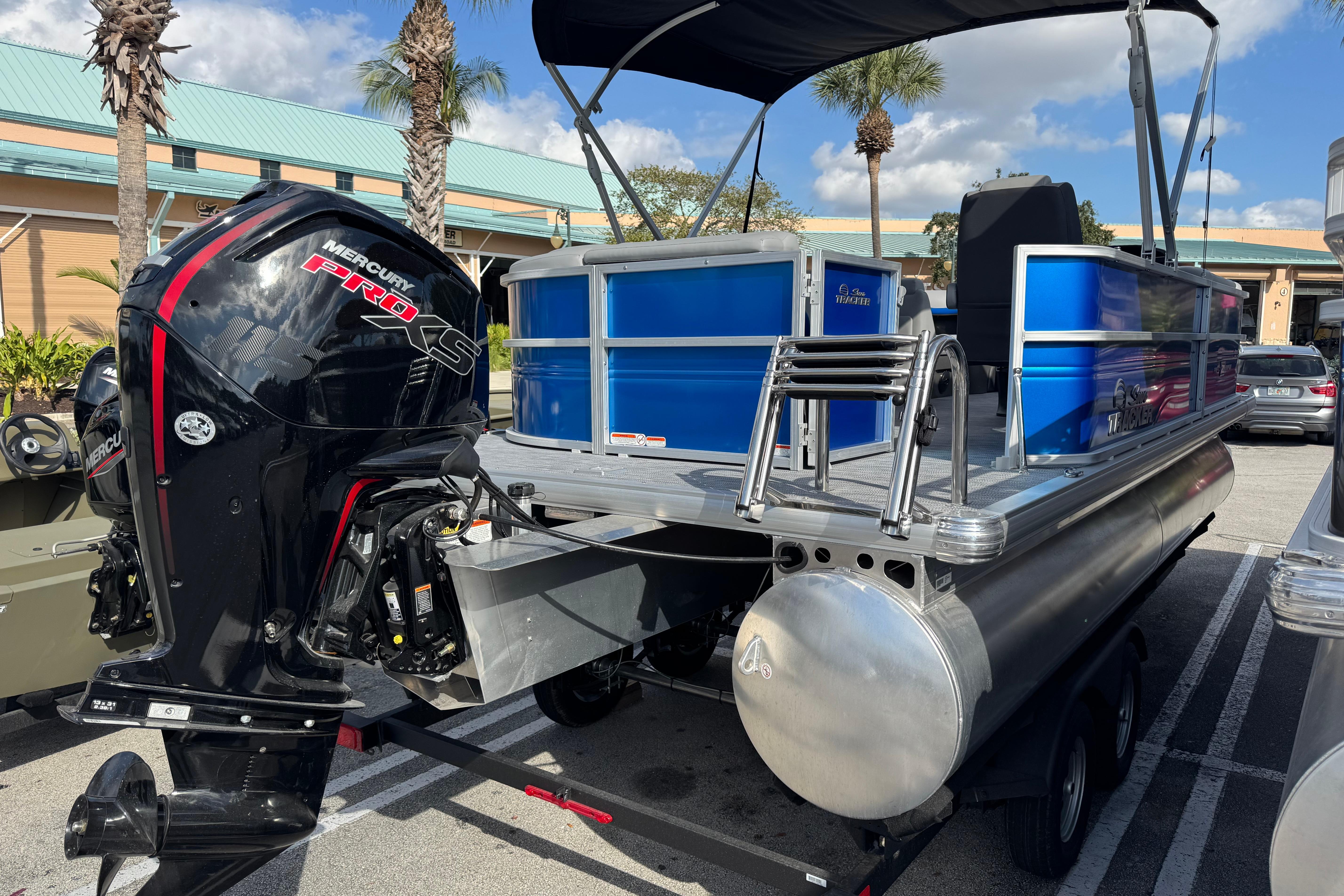 2026 Sun Tracker Party Barge 20 DLX with Mercury Pro XS engine, parked outdoors.