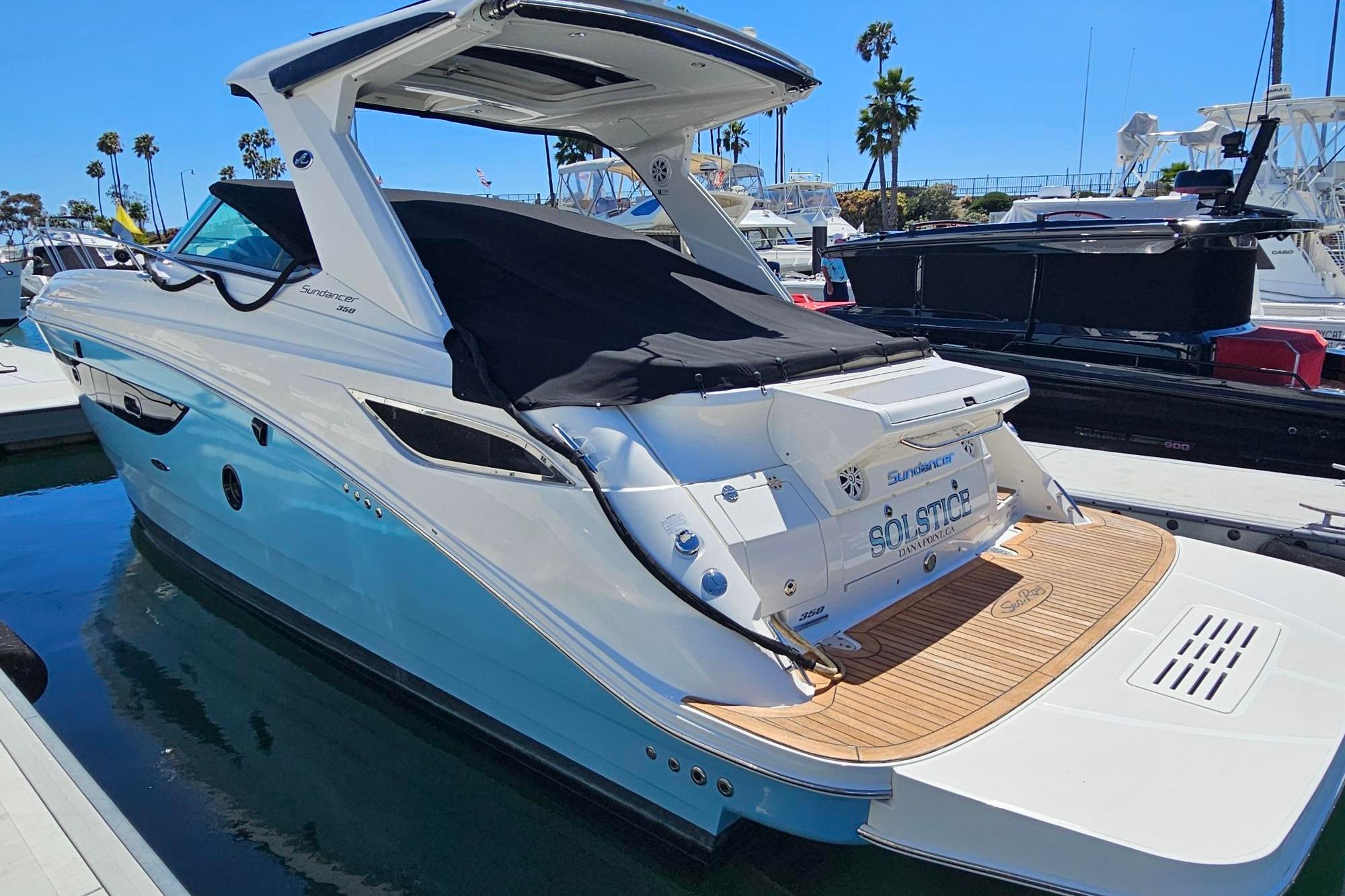 2016 Sea Ray Sundancer 350 yacht docked at marina, featuring sleek design and spacious deck.