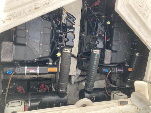 Engine compartment of a 2000 Cruisers 3870 boat, showcasing dual engines and mechanical components.