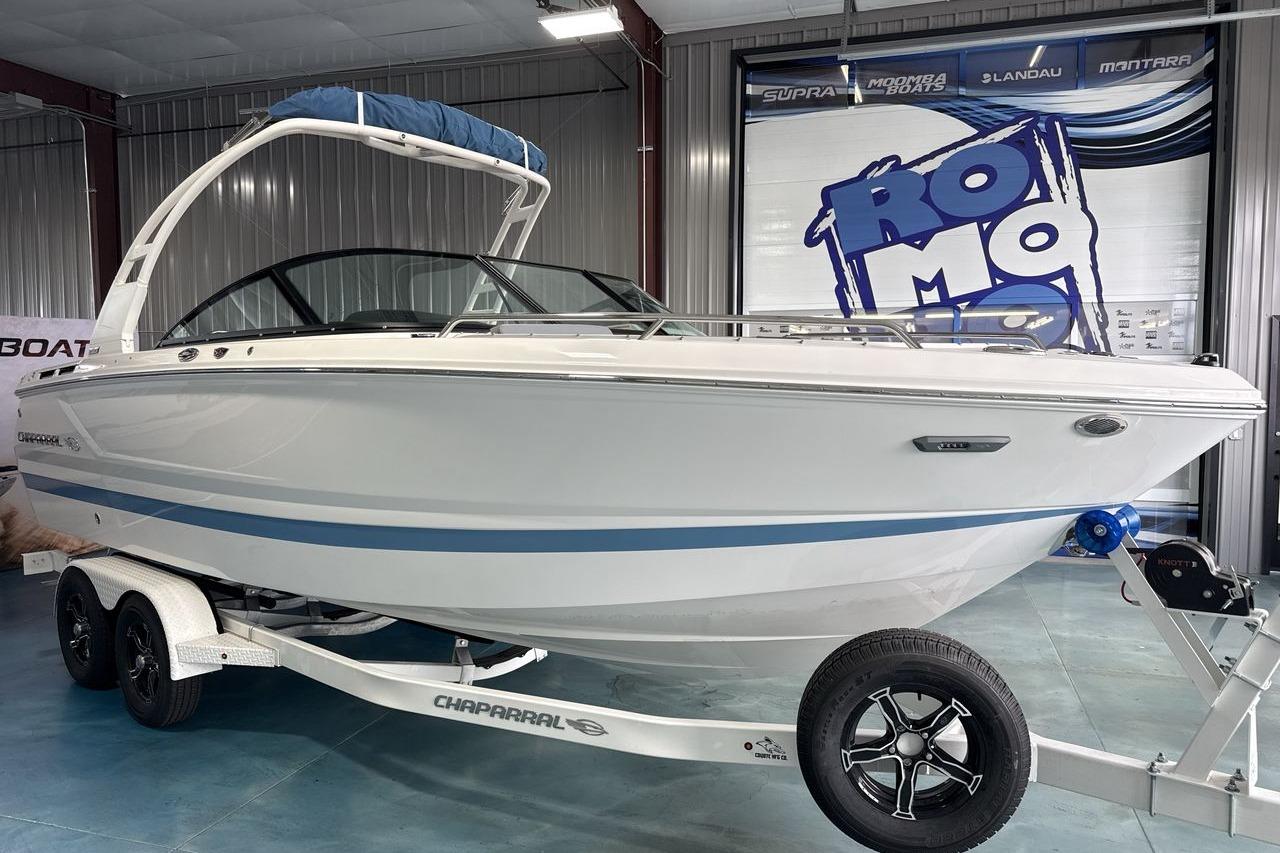 A white 2026 Chaparral SSX 4 boat on a trailer inside a showroom.