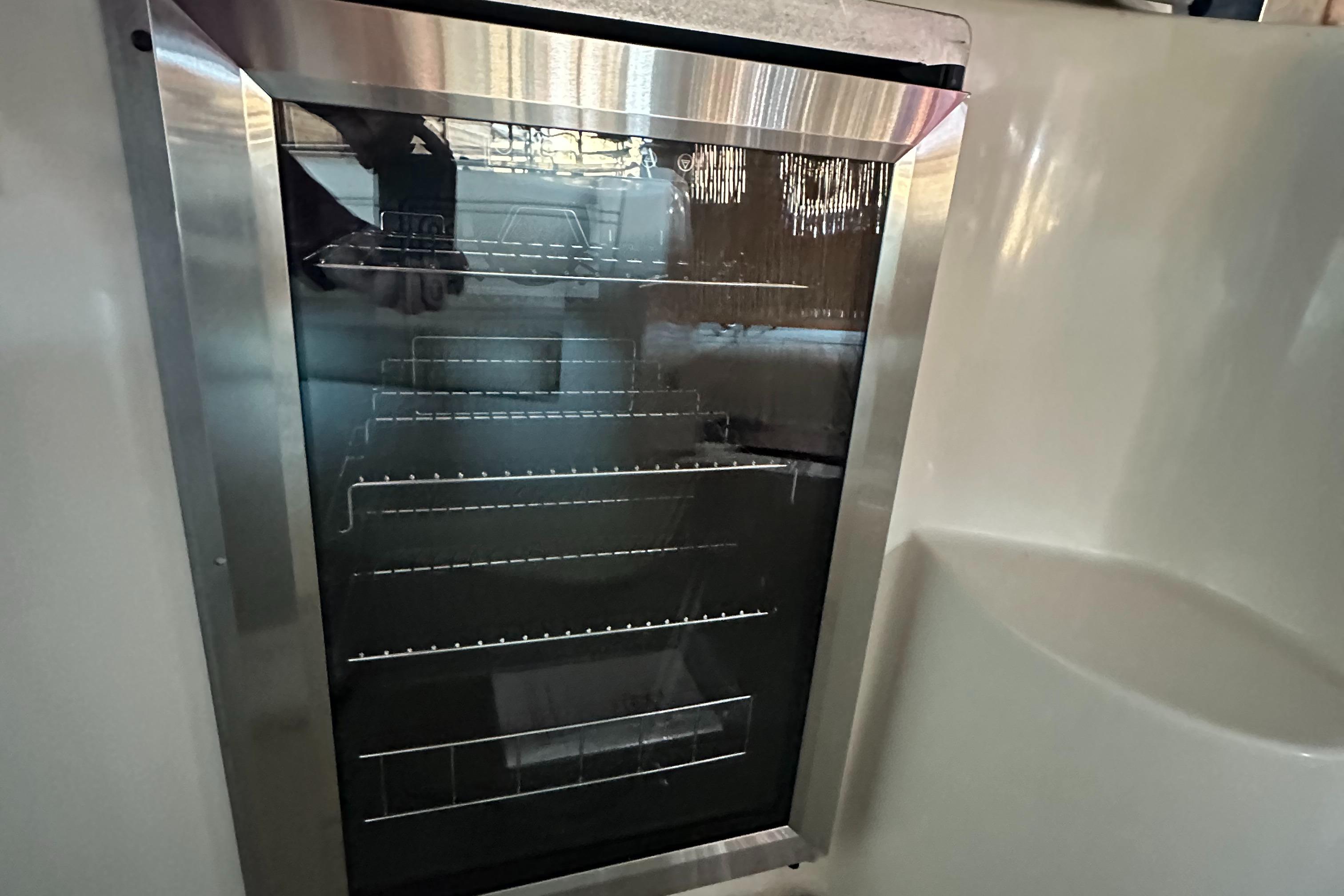 2003 Rinker Fiesta Vee 312 boat interior fridge with wire shelves.