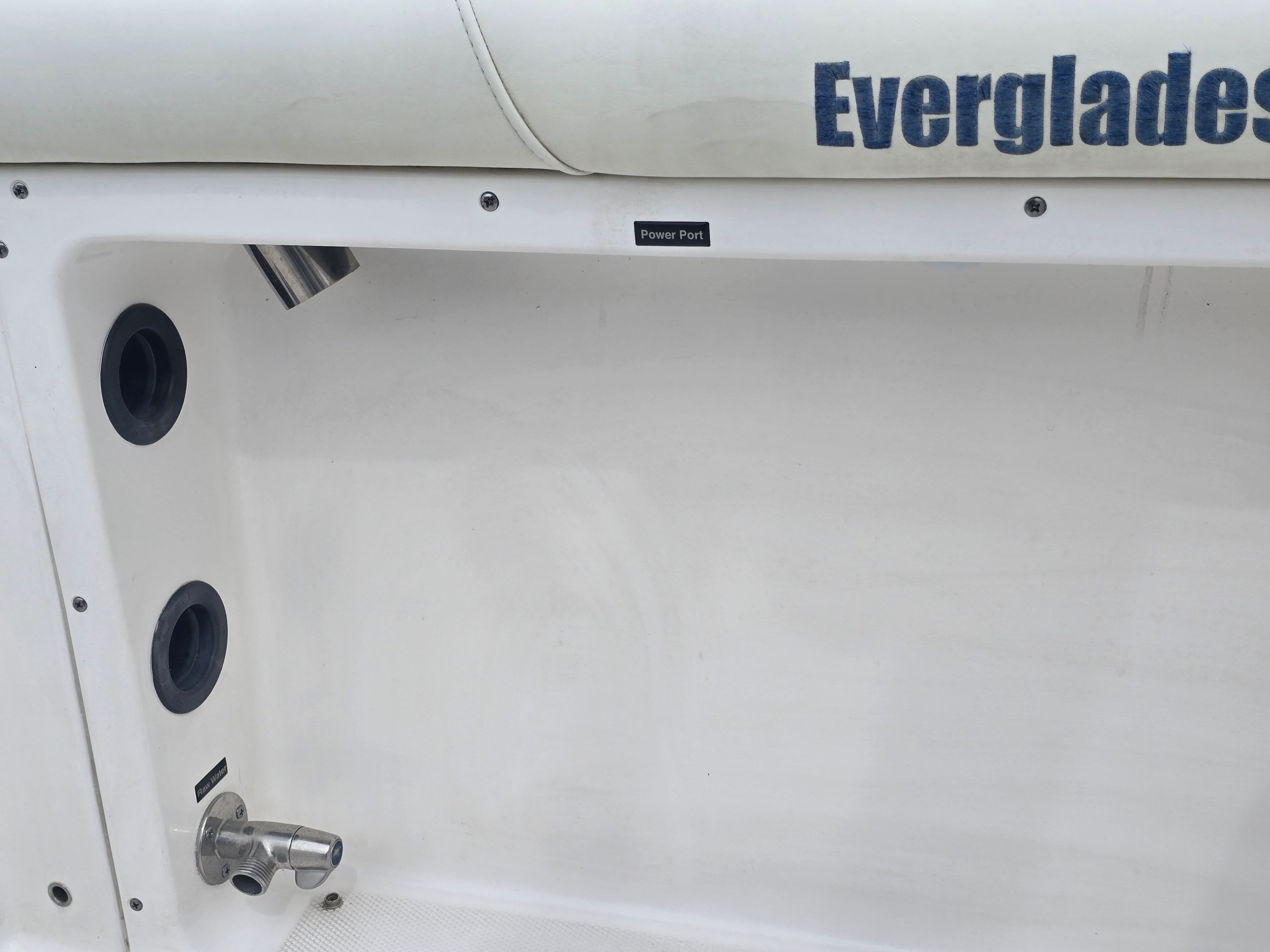 Close-up of the Everglades 230 Dual Console boat, 2017 model, showing ports and upholstery.