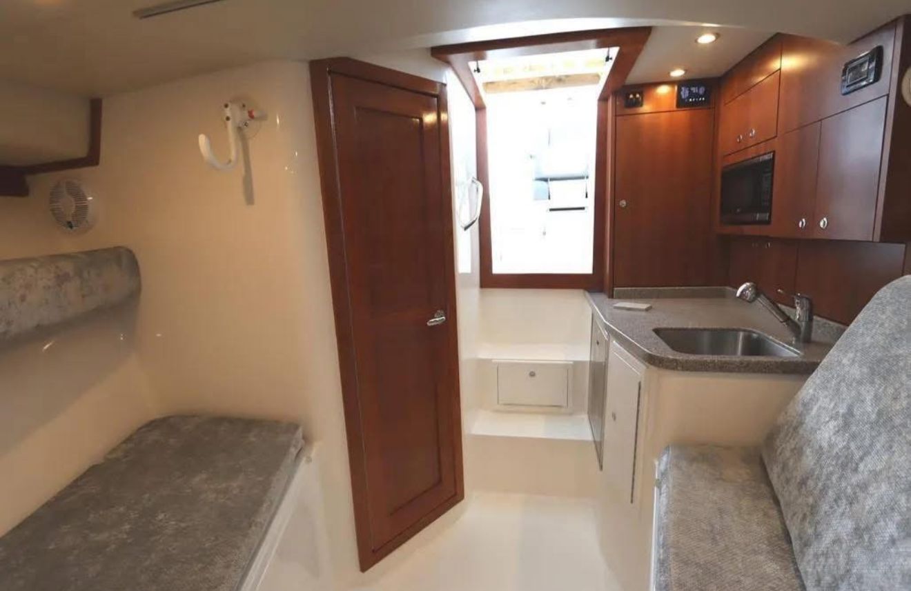 Interior of the 2024 Albemarle 30 Express with kitchenette, seating area, and sleeping space.