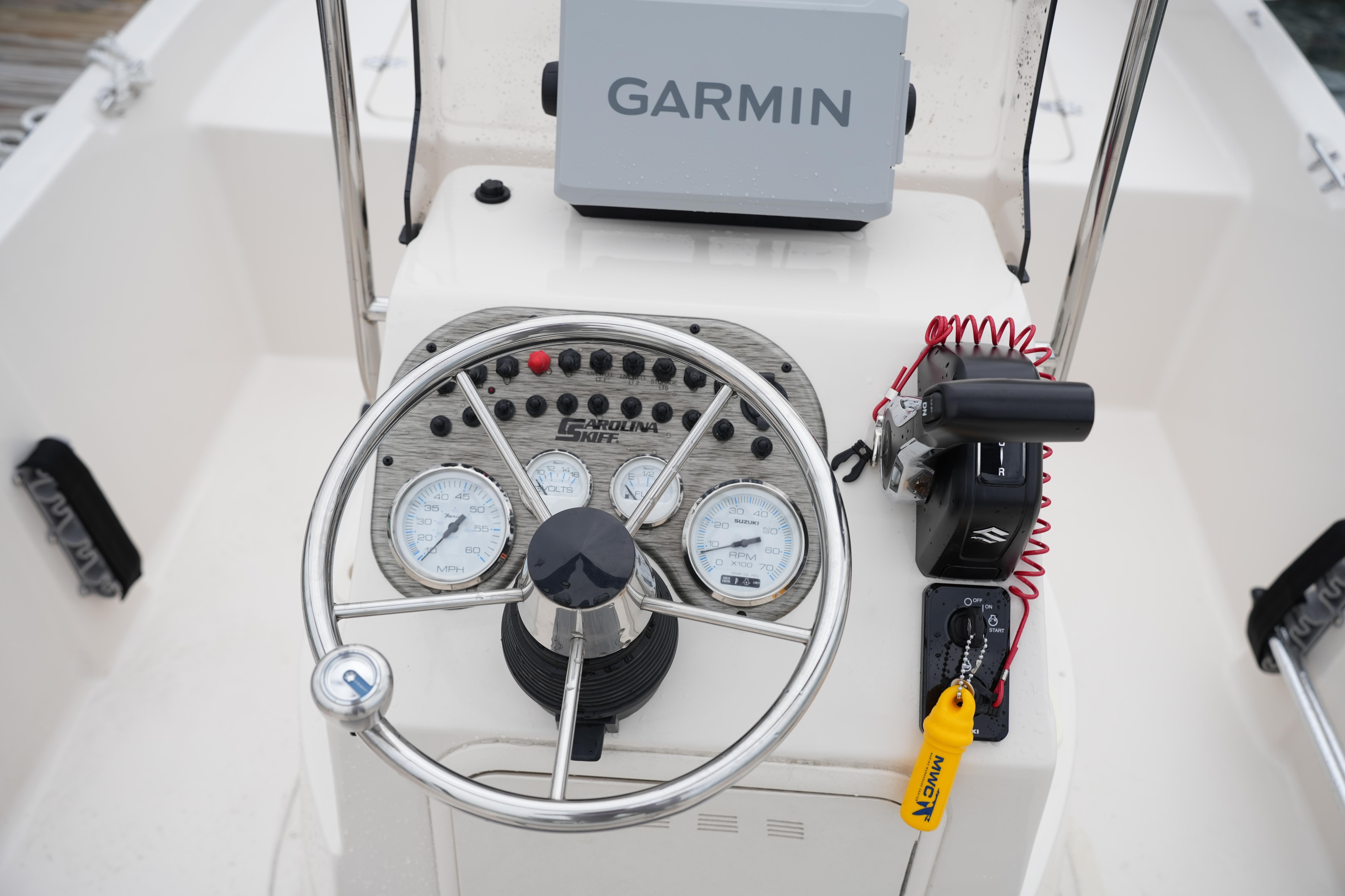 2025 Carolina Skiff 162 JLS boat dashboard with Garmin GPS and steering wheel.