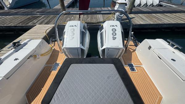 2025 Nimbus T11 boat with twin 400 horsepower outboard engines at dock.