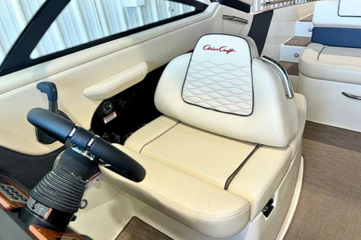 2025 Chris-Craft Sportster 25 boat interior with luxurious seating and steering wheel.