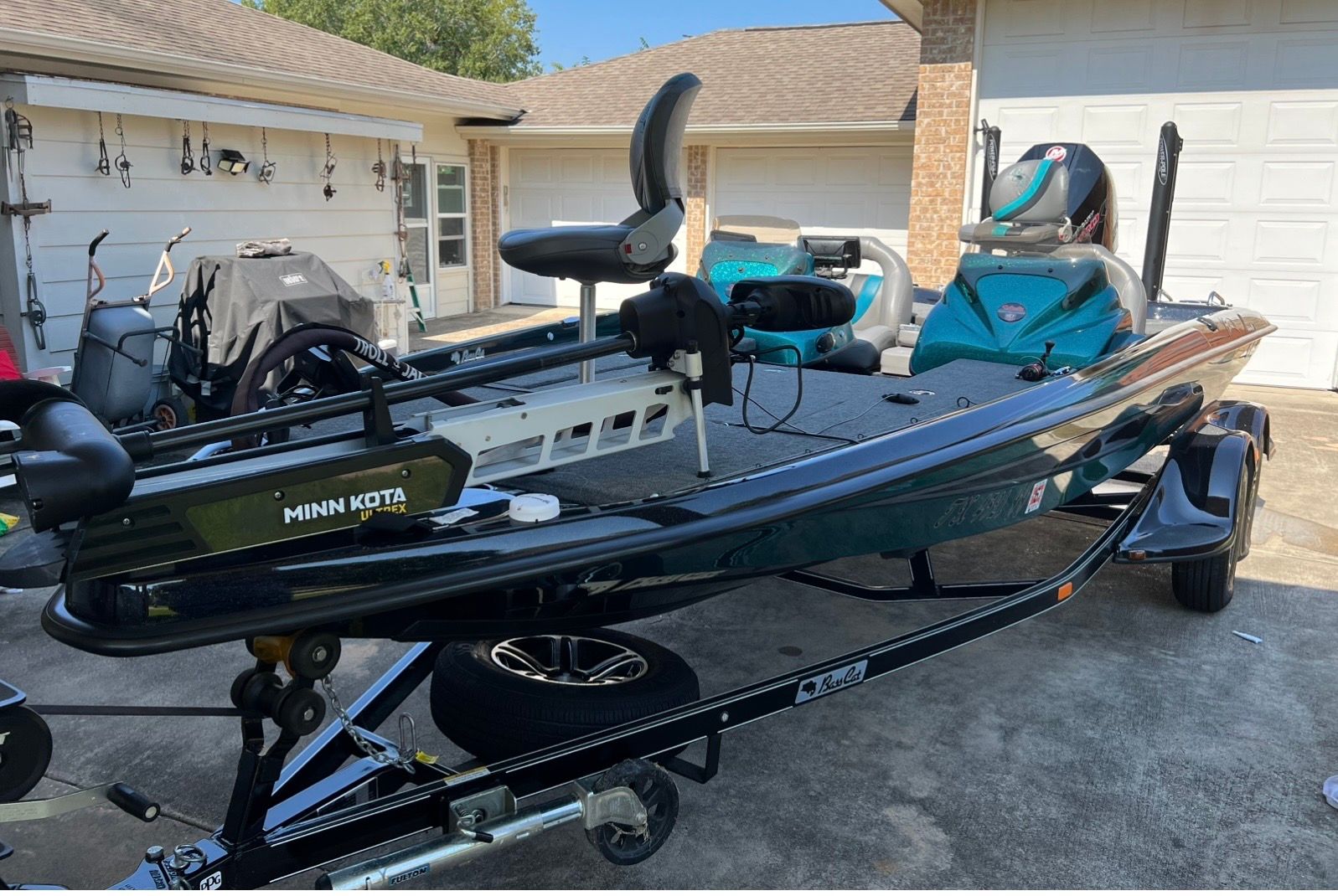 A 2020 Bass Cat Pantera II on a trailer in a driveway.