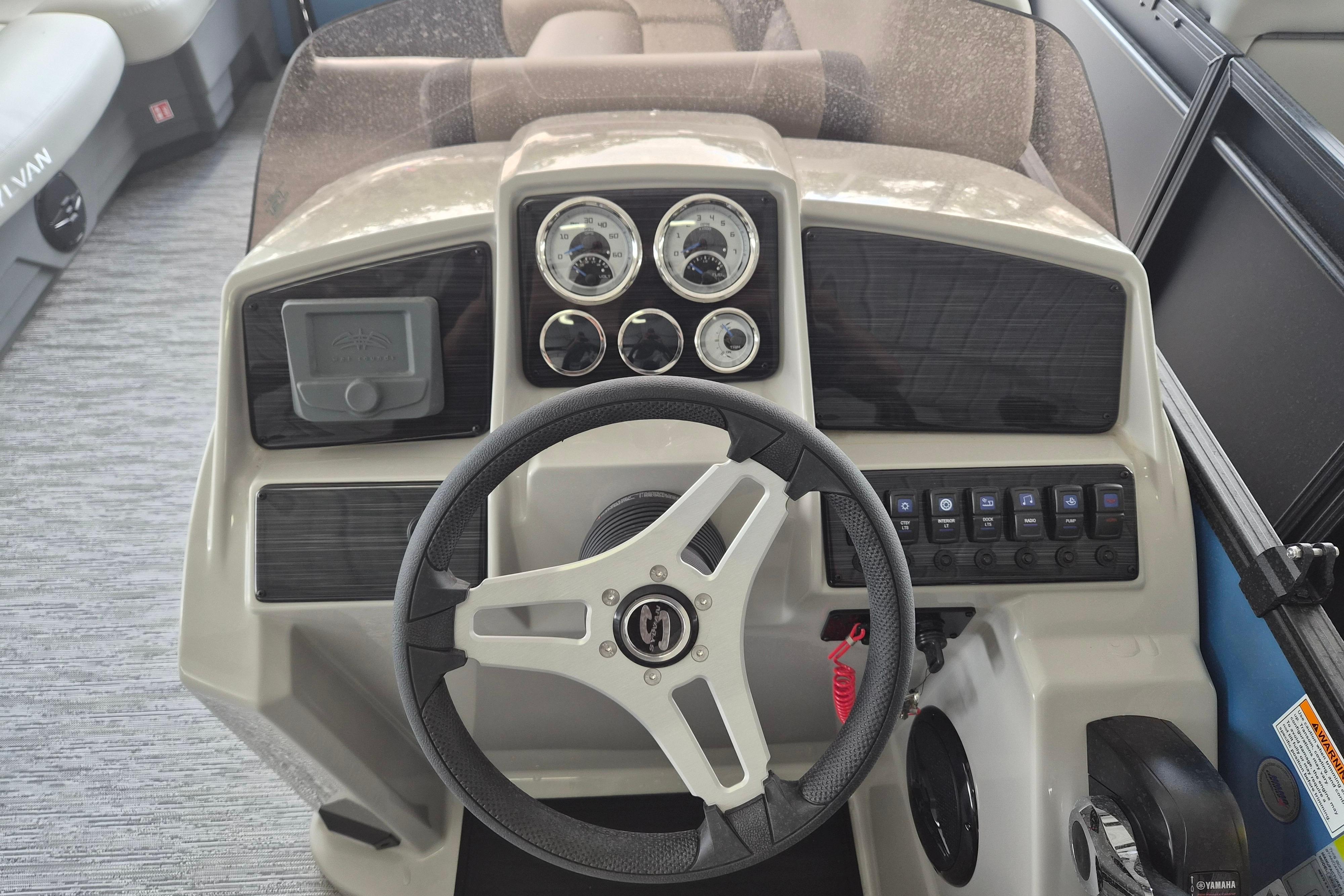 Steering console of 2026 Sylvan Mirage Fish 820 Party Fish boat with gauges and controls.