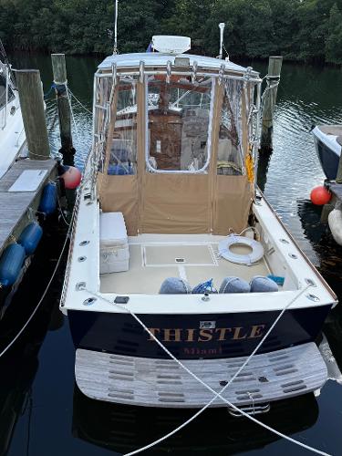1978 Dyer 29 Trunk Cabin boat named "Thistle" docked at a marina.