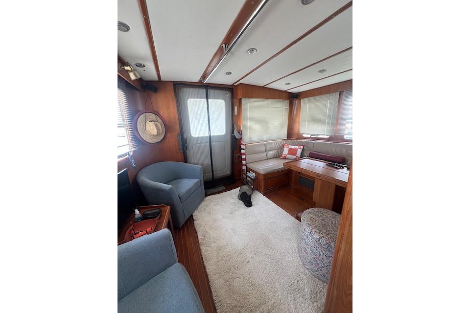 Interior of 1998 Nordhavn 46 yacht with cozy seating and nautical decor.