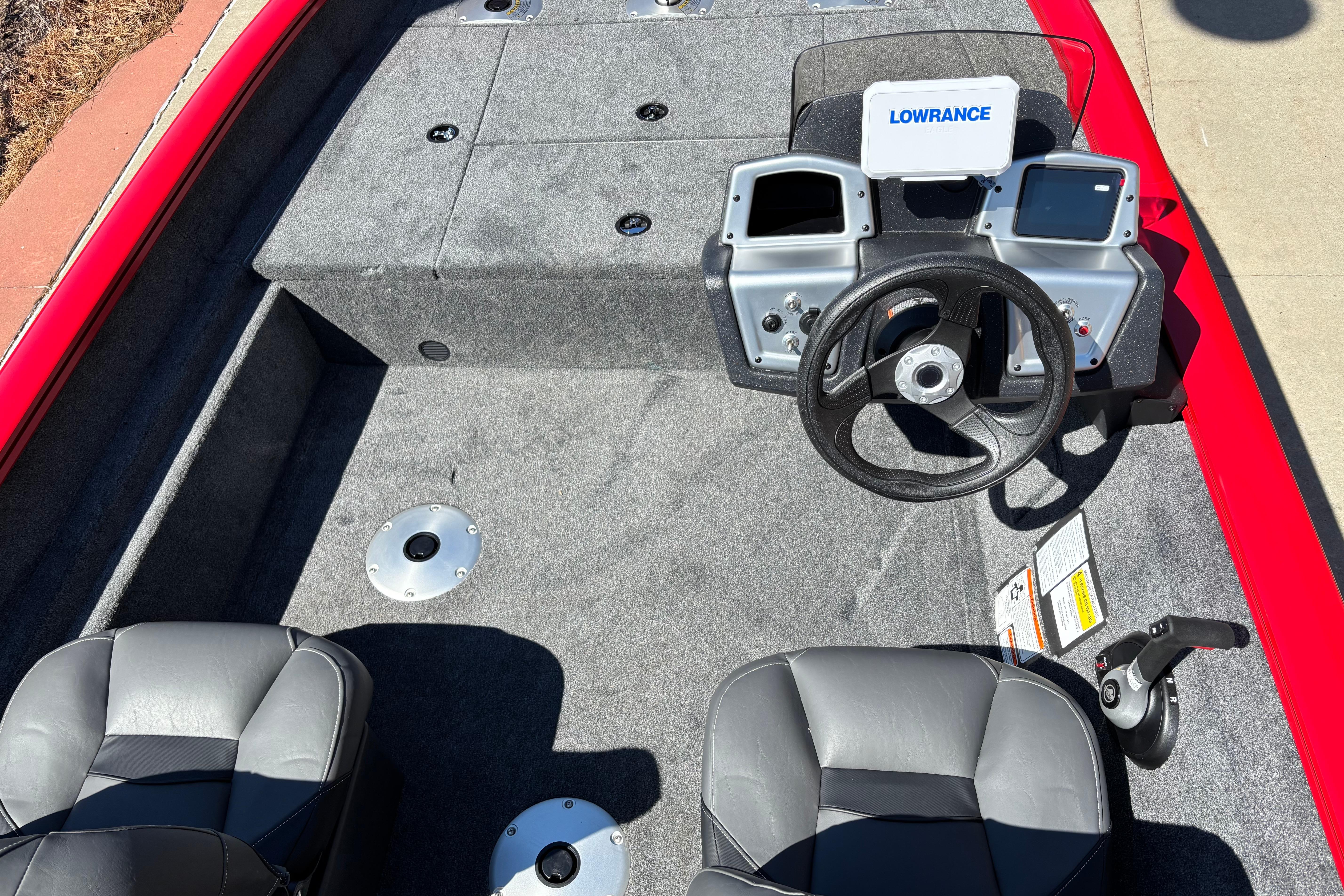 2026 Tracker Pro Team 175 Crappie Edition boat interior with steering wheel and Lowrance electronics.