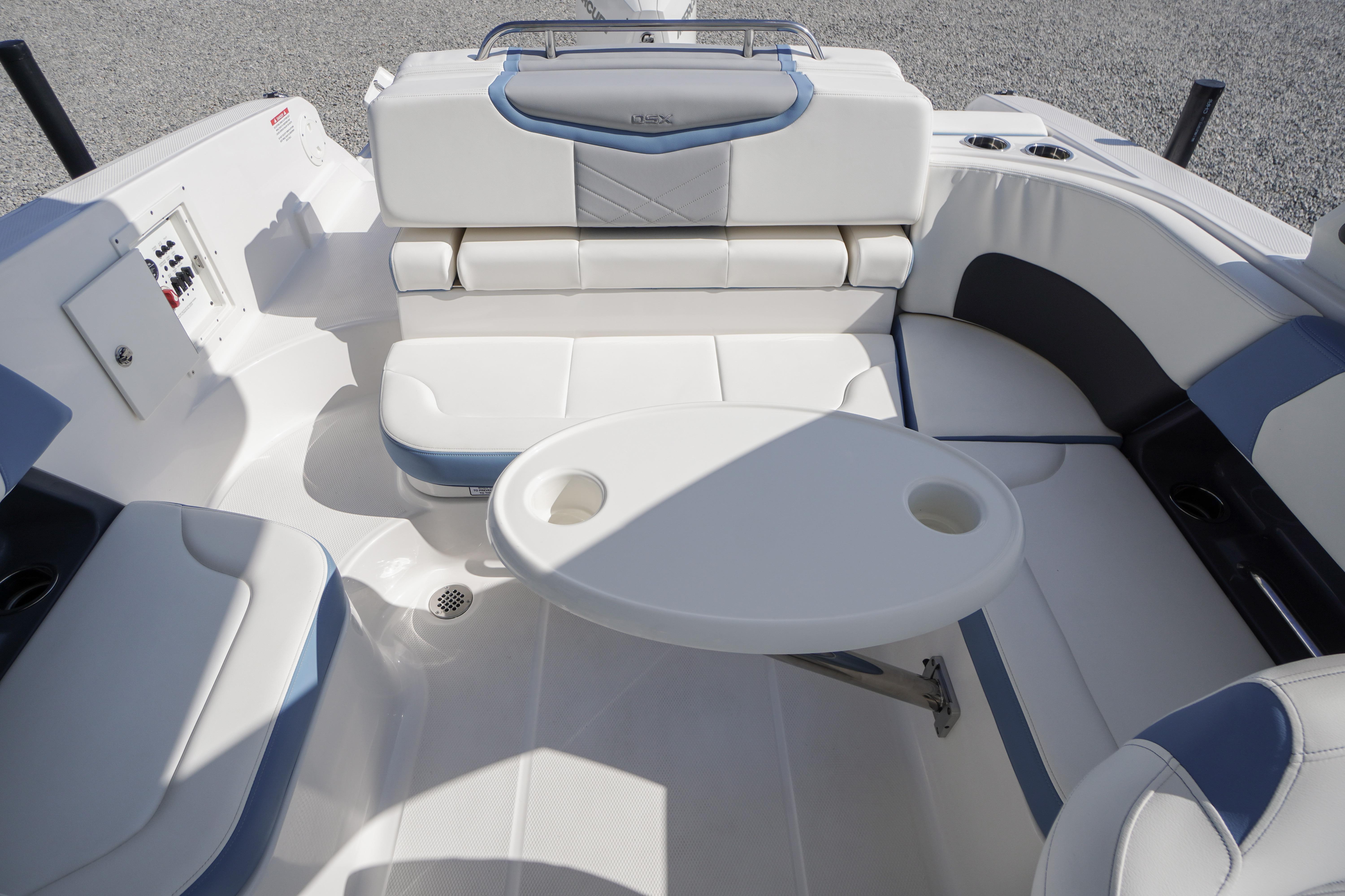 2026 Chaparral 270 OSX boat interior with white seating and round table.
