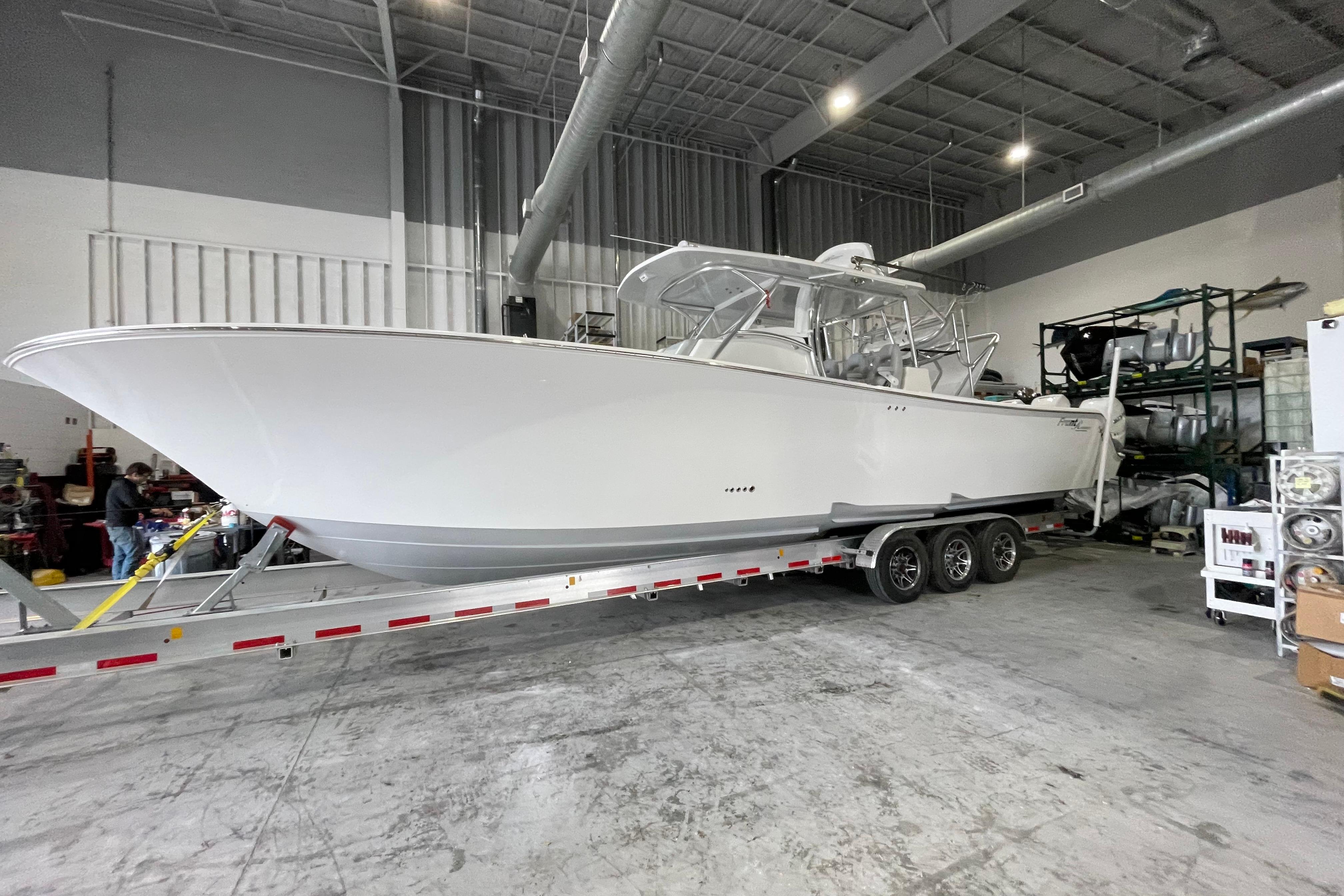 2020 Front Runner 39 Center Console boat on trailer in warehouse setting.