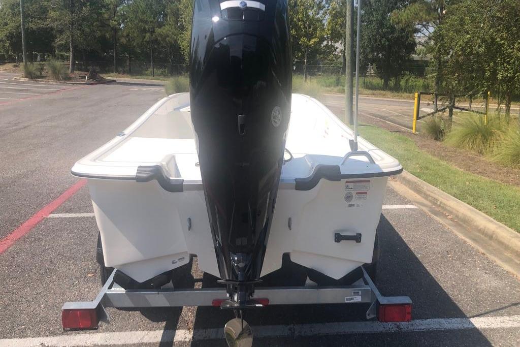 2026 Mako Pro Skiff 17 CC boat on trailer, rear view in parking lot.