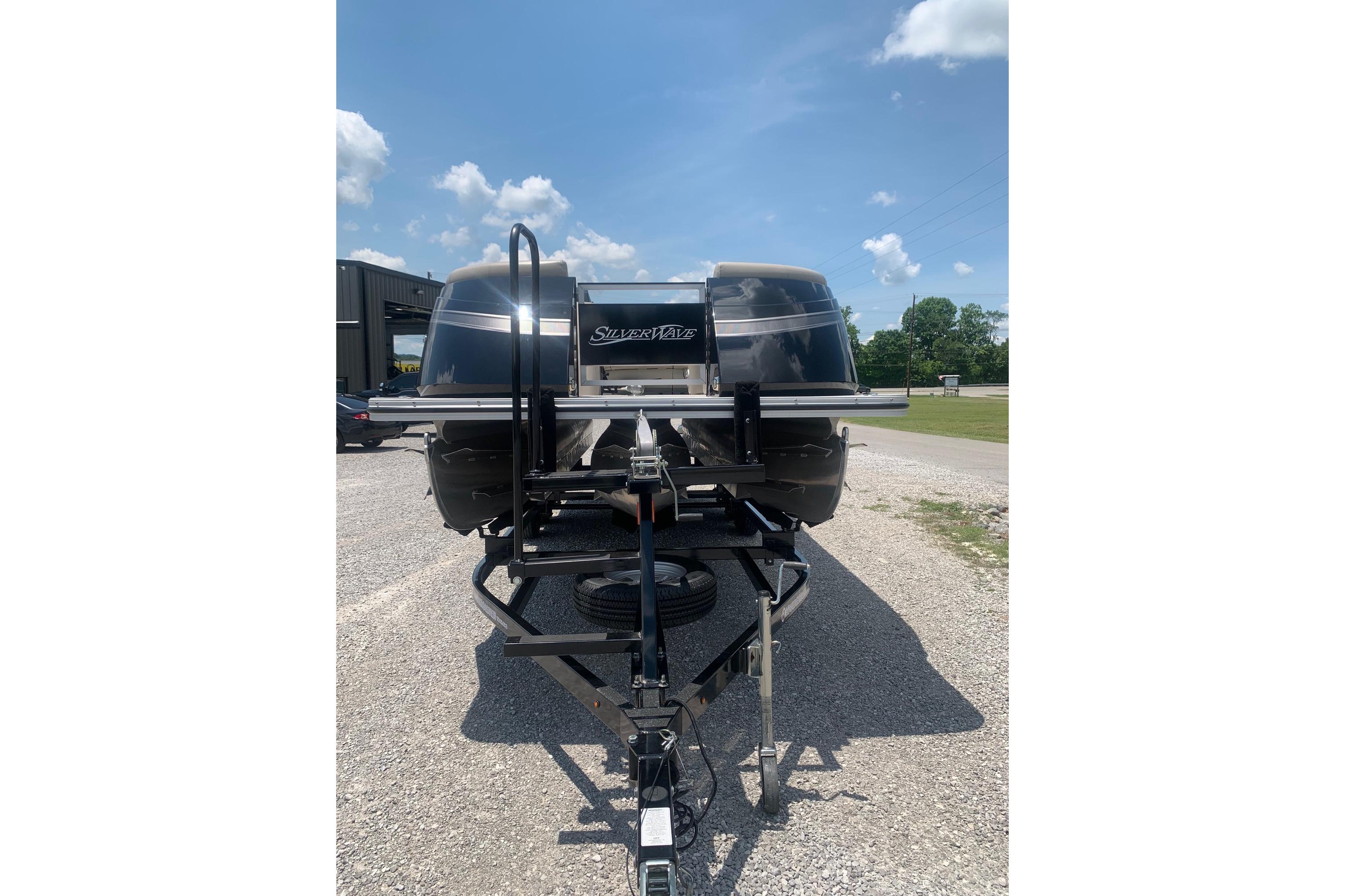 2023 Silver Wave 2410 SW3 CLS boat on trailer under blue sky.