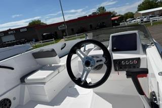 2026 Tahoe T18 boat interior with steering wheel and control panel.