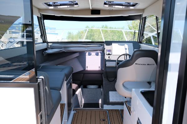 Interior of 2023 Makaira Gen3 800 boat, featuring modern seating and navigation area.