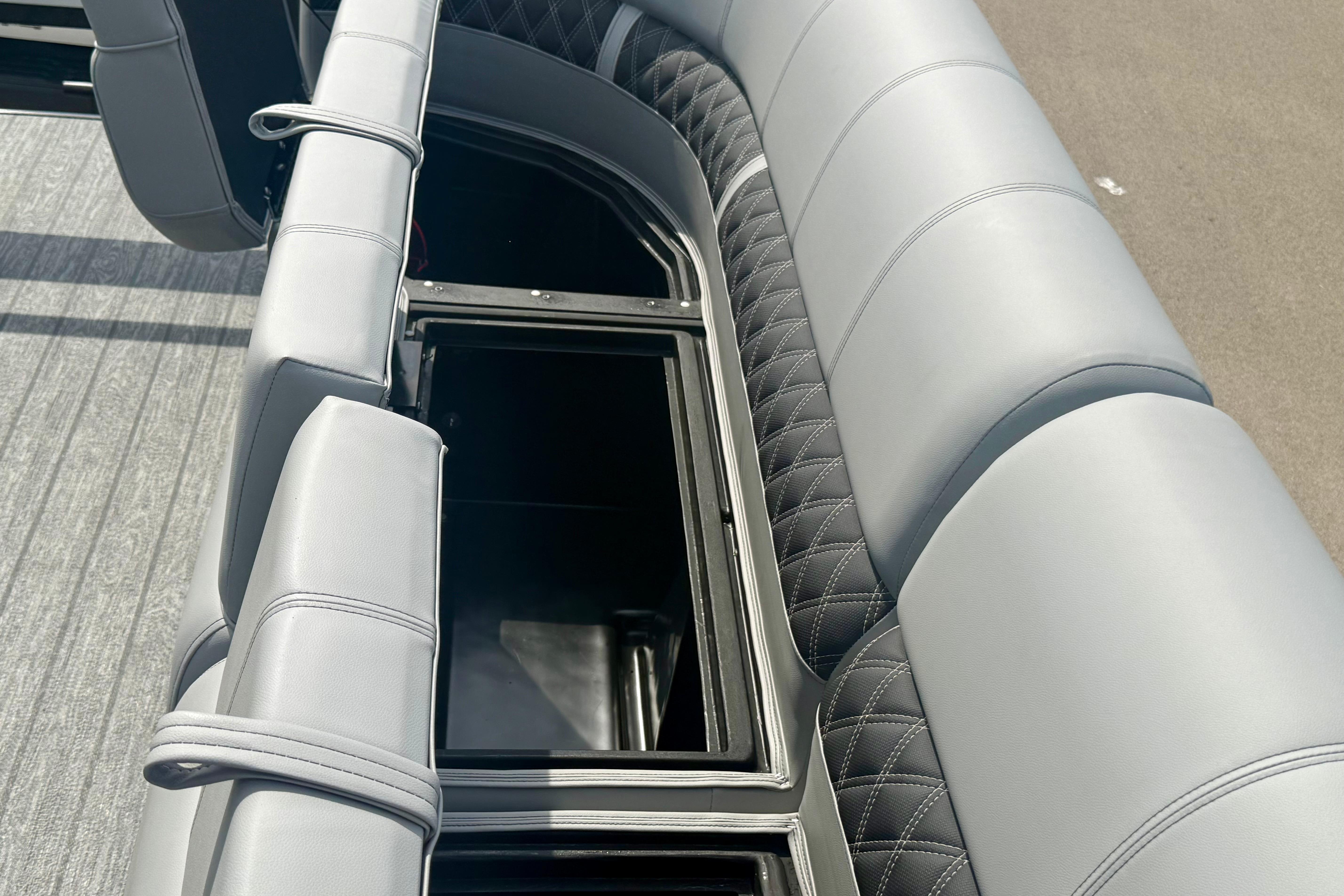 2026 Ranger 223FC boat with luxurious gray seating and storage compartment.