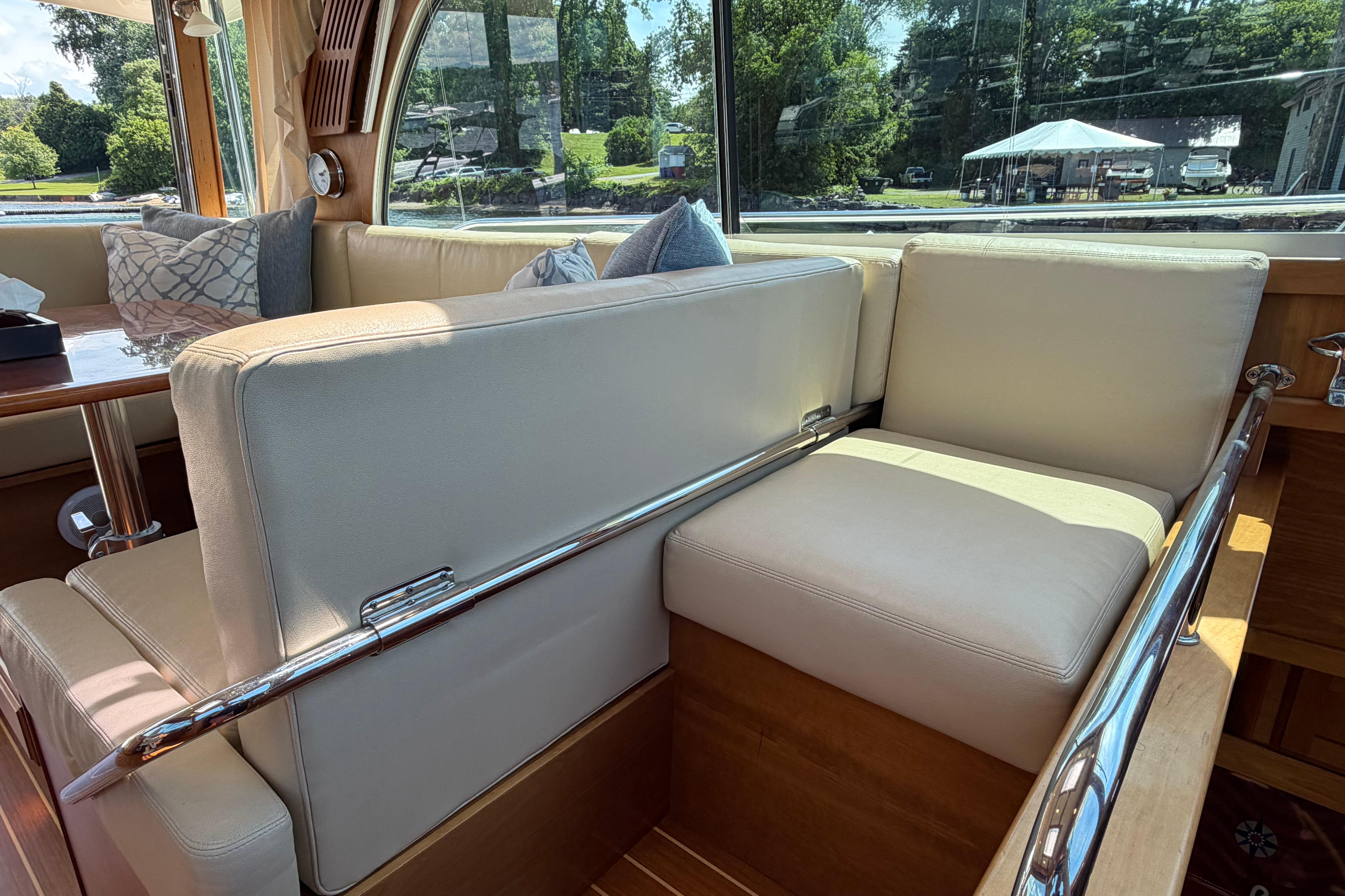 Interior of 2015 Sabre 38 Salon Express with cream seating and large windows.