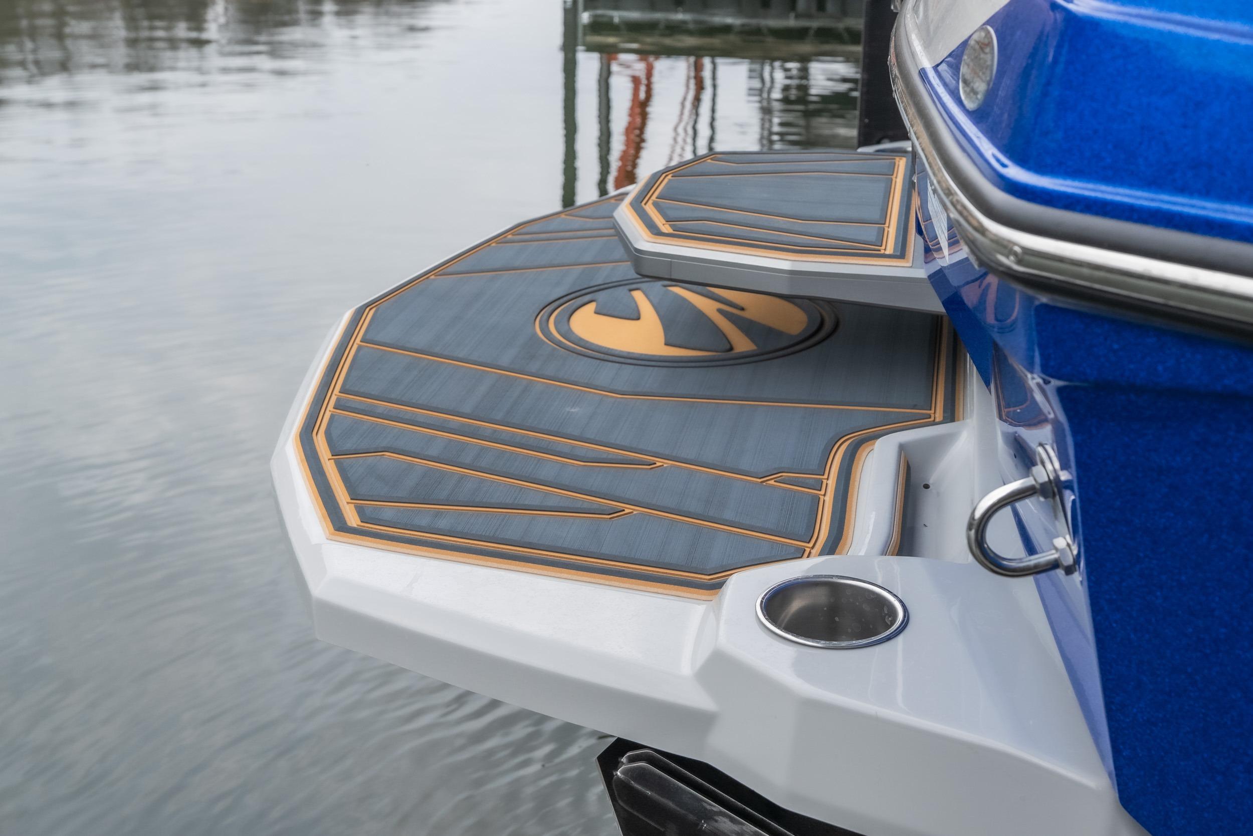 2026 Tigé Z3 boat swim platform with stylish design and logo, docked on calm water.
