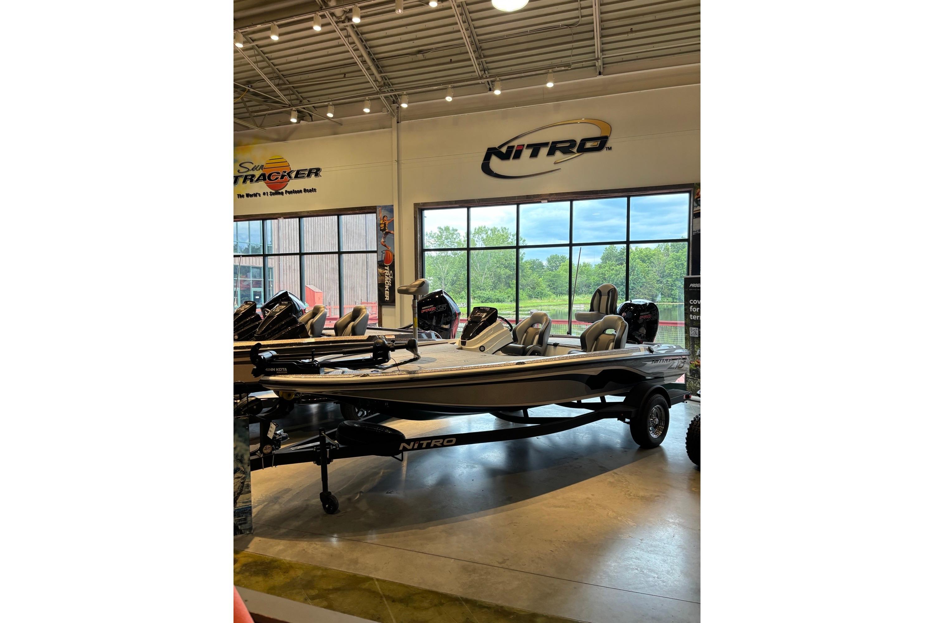 2025 Nitro Z18 boat displayed in showroom with large windows and overhead lighting.
