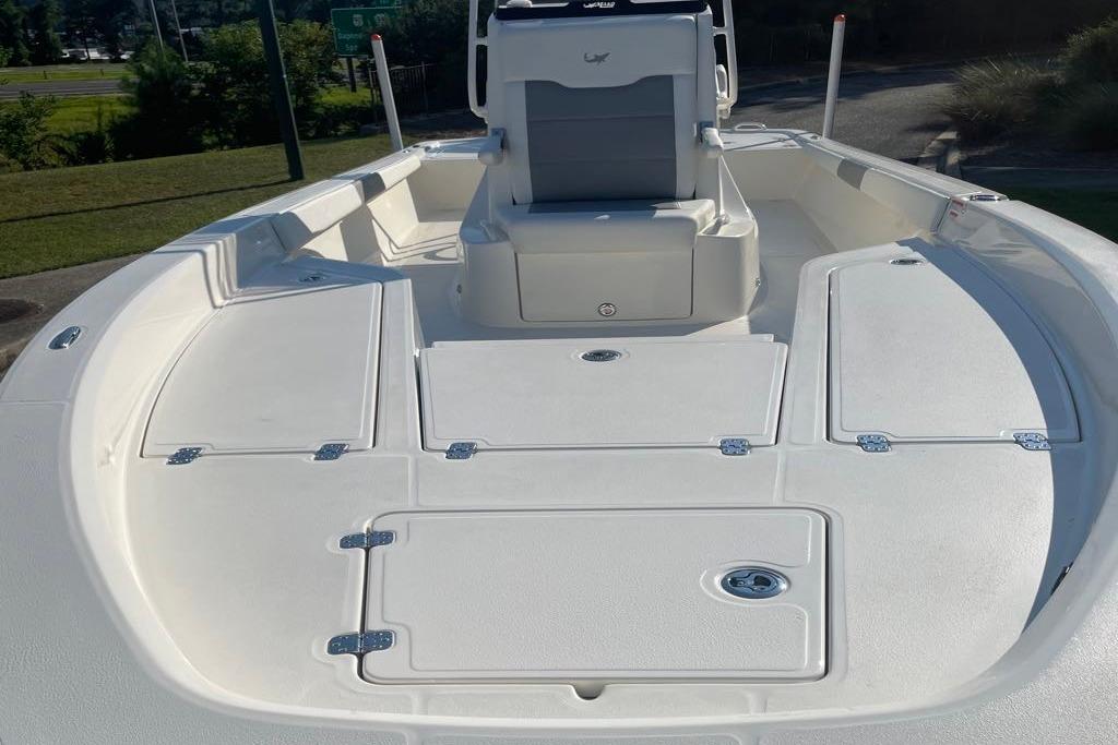 2026 Mako 24 APEX boat deck with storage compartments and seating.