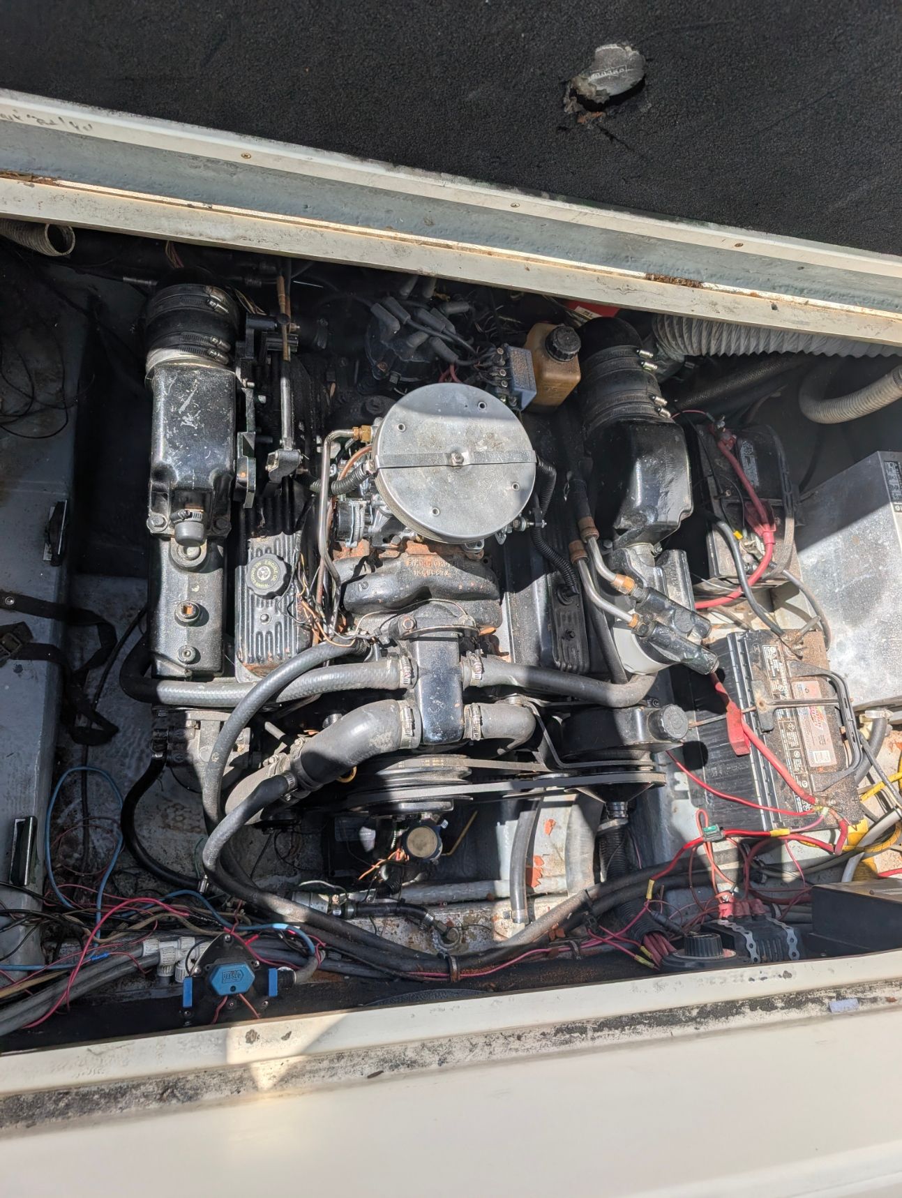 Engine compartment of a 1995 Rinker Fiesta Vee 265 with visible wires and components.