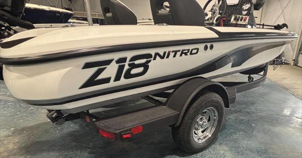 2025 Nitro Z18 boat on trailer in showroom setting.