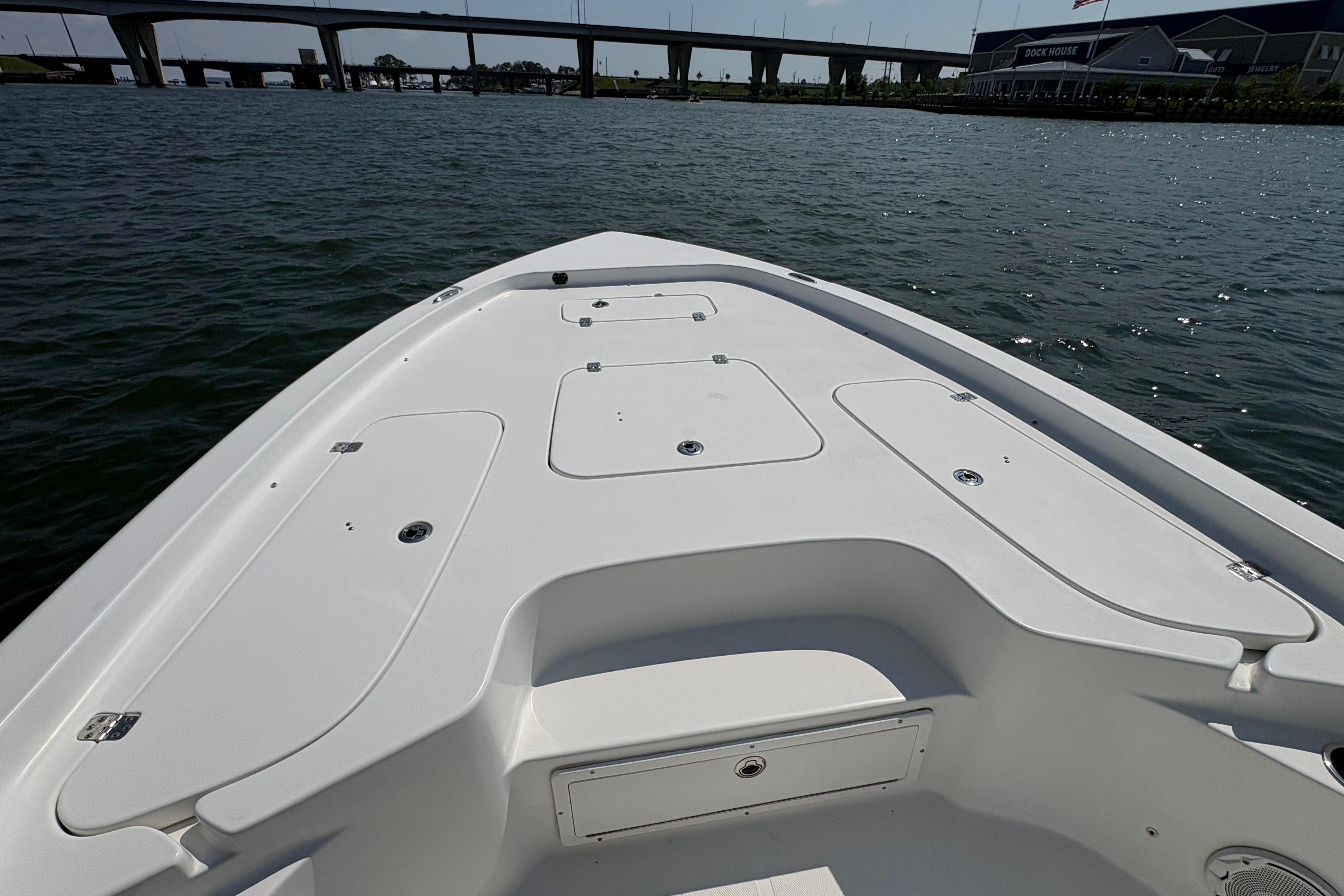 2017 Sea Hunt BX 25 BR boat deck on calm water near a bridge.