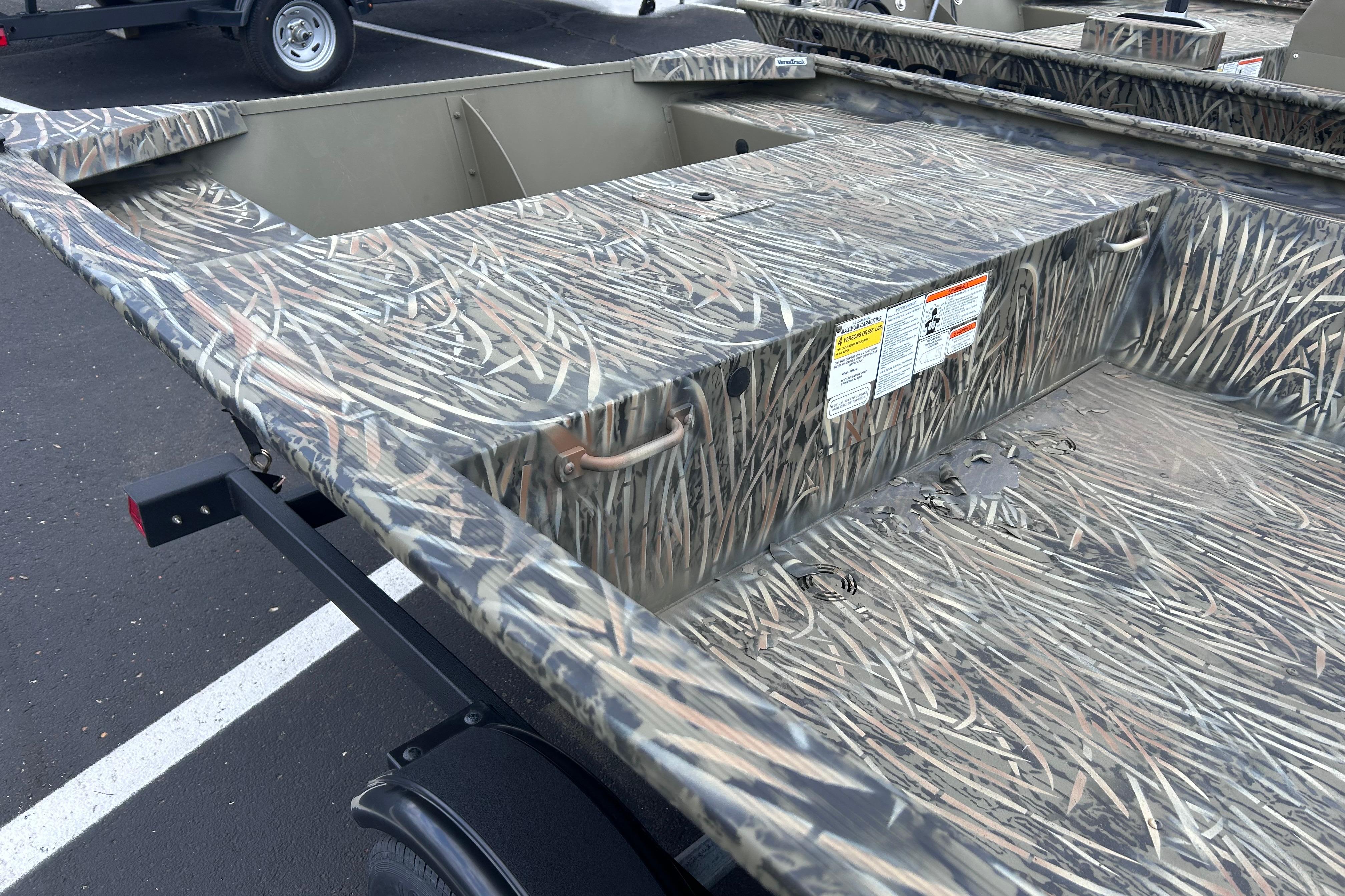 2026 Tracker Grizzly 1648 Utility boat with camouflage design on a trailer.