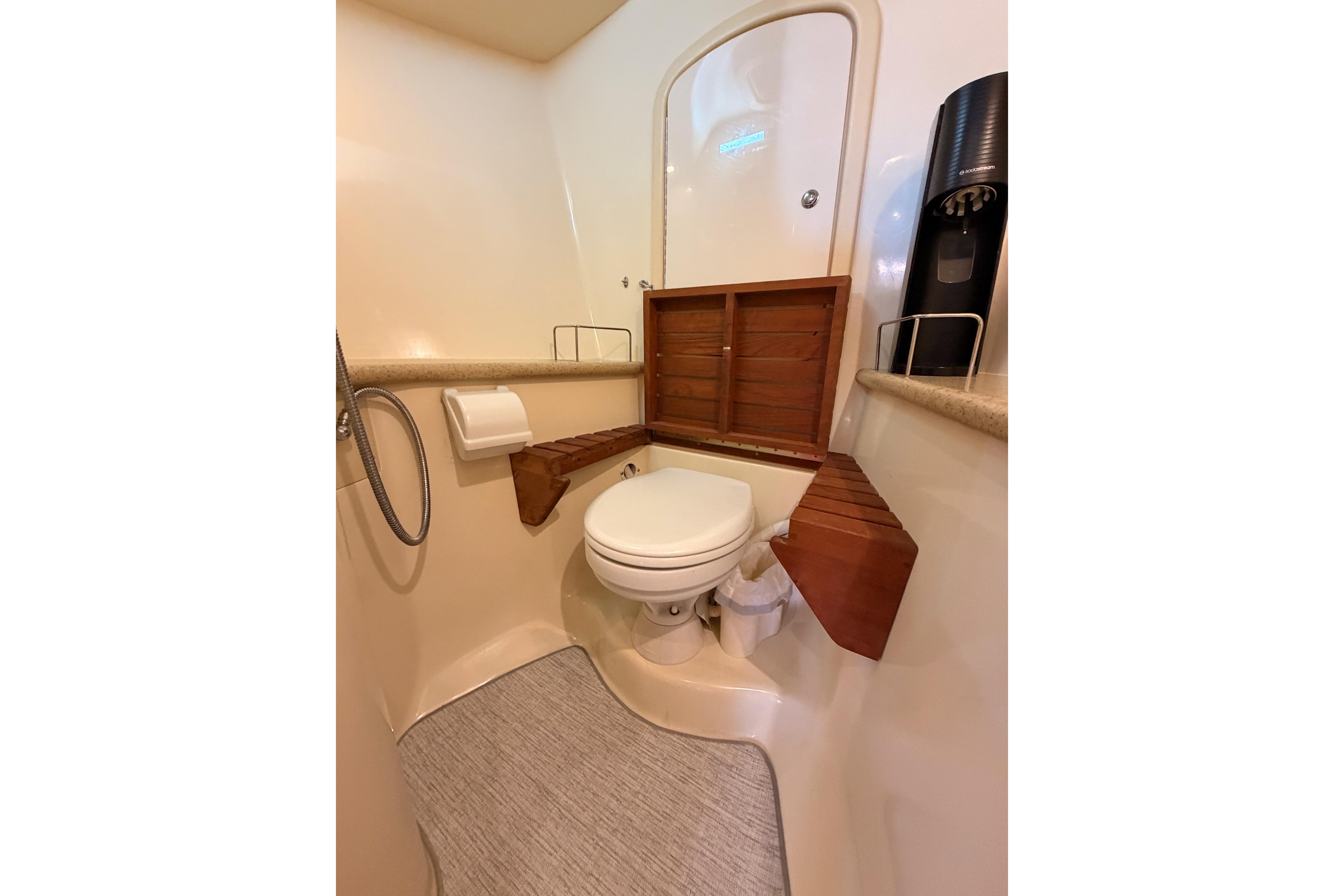 Bathroom interior of 2008 Hunter 45 Deck Salon yacht, featuring toilet and wooden accents.