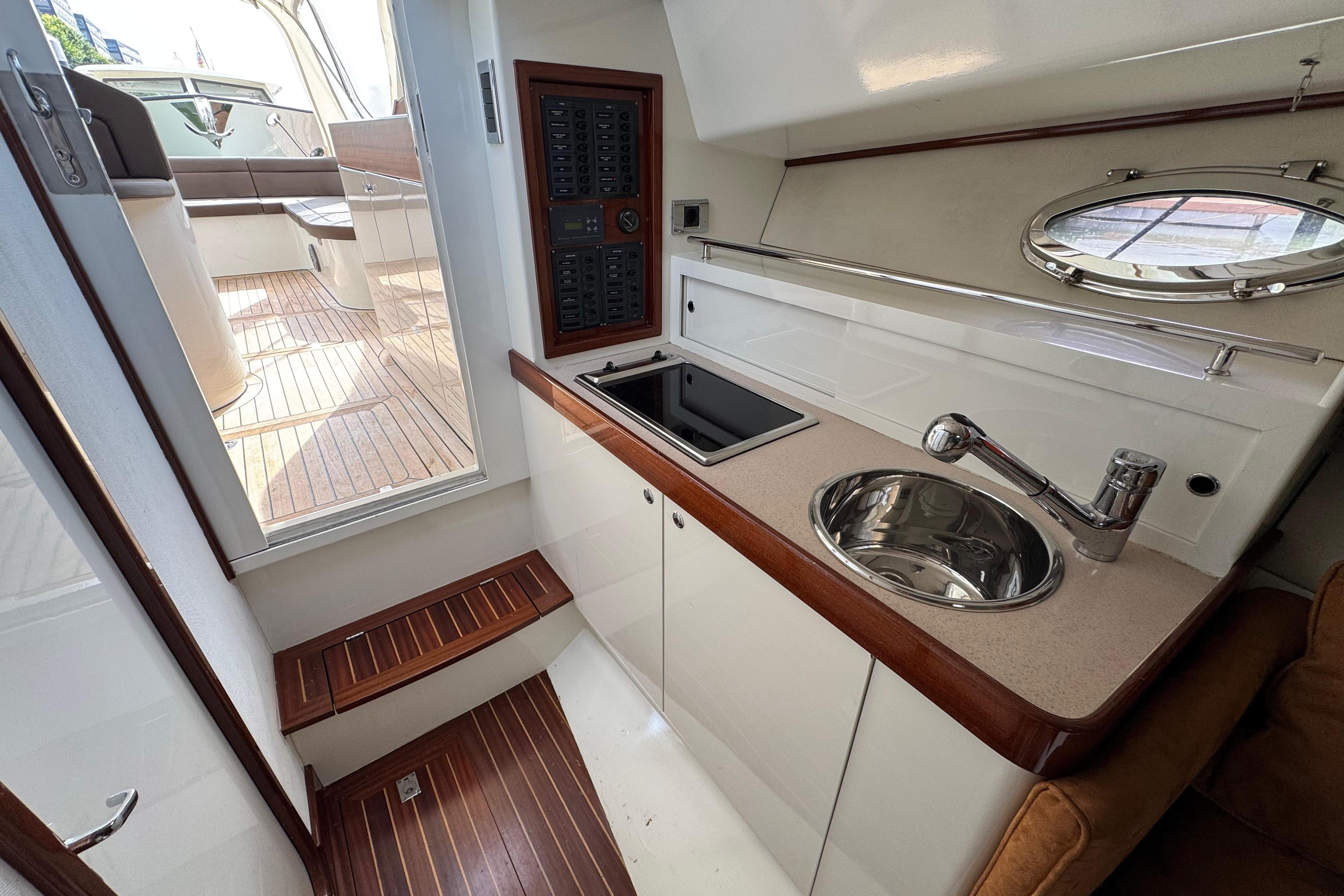 2006 Gagliotta Grand Azur Classic 33 yacht interior with kitchenette and wooden flooring.