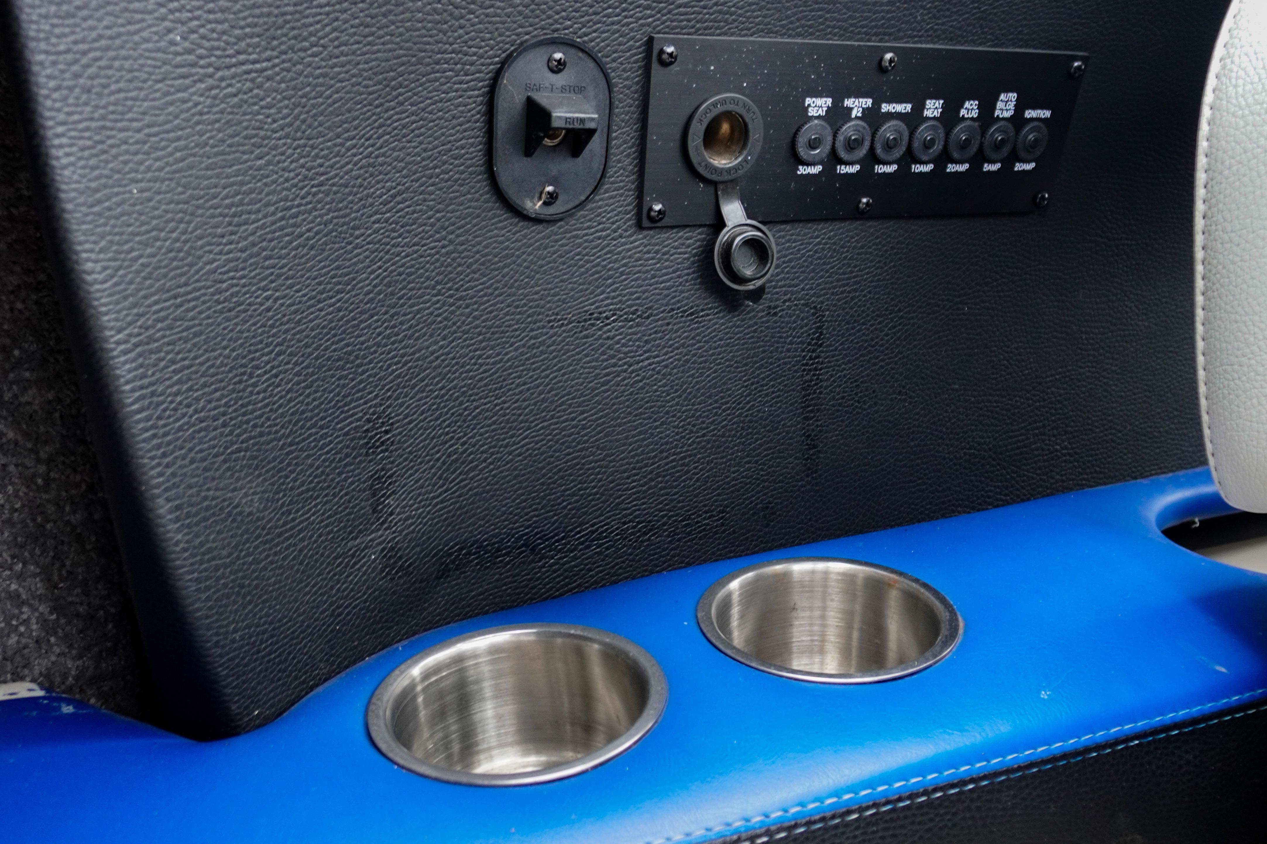 2011 Malibu Wakesetter 21 VLX interior panel with switches and cup holders.