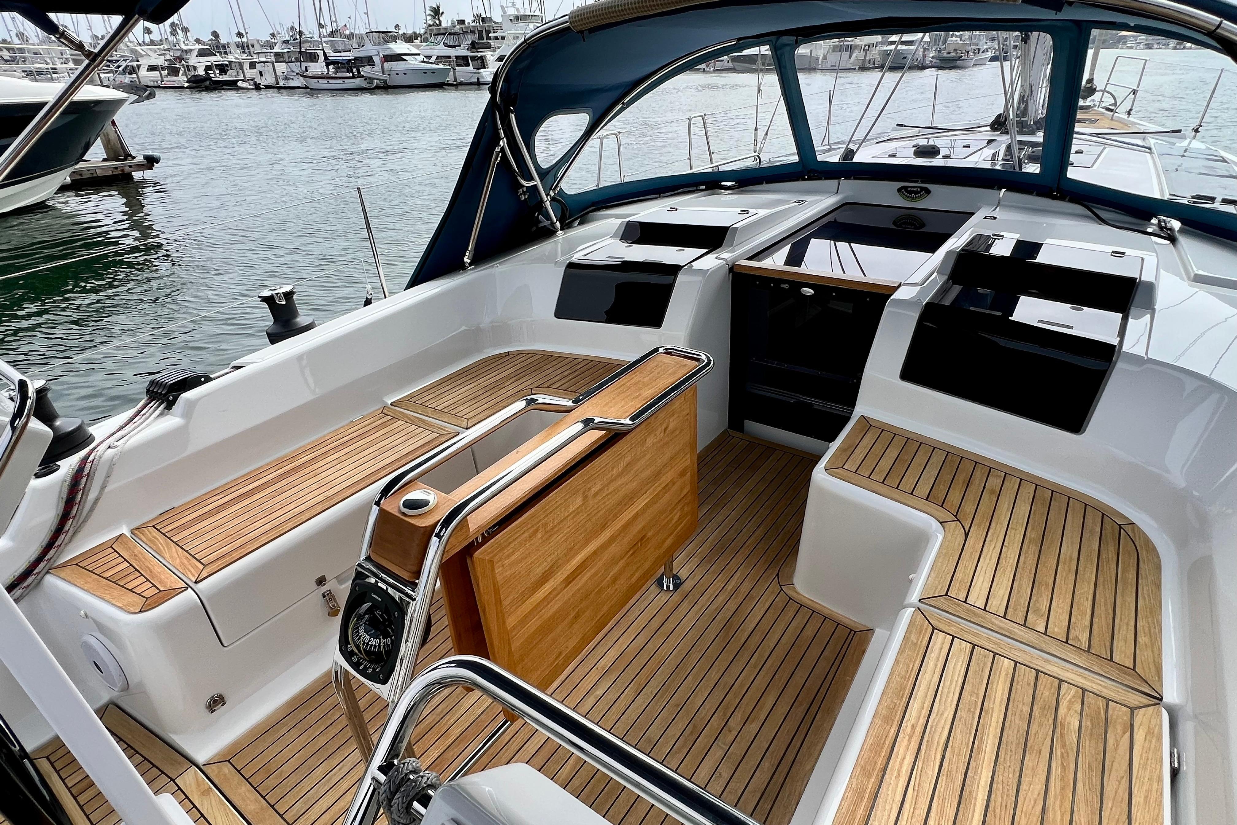 2016 Hanse 455 yacht cockpit with teak flooring, docked at marina.