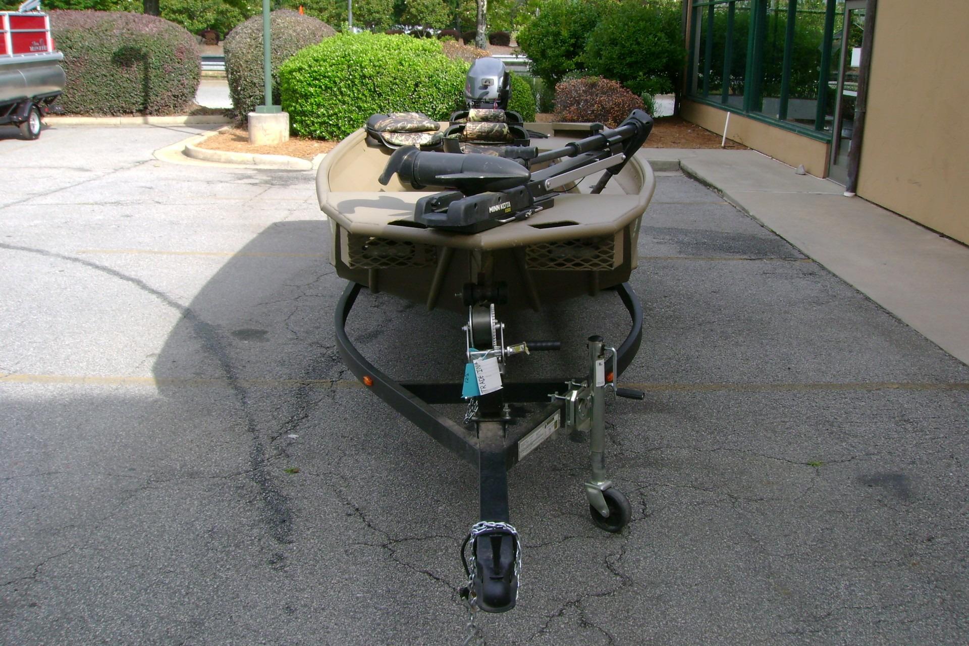 2023 G3 1652 DK boat on trailer in parking lot, front view.