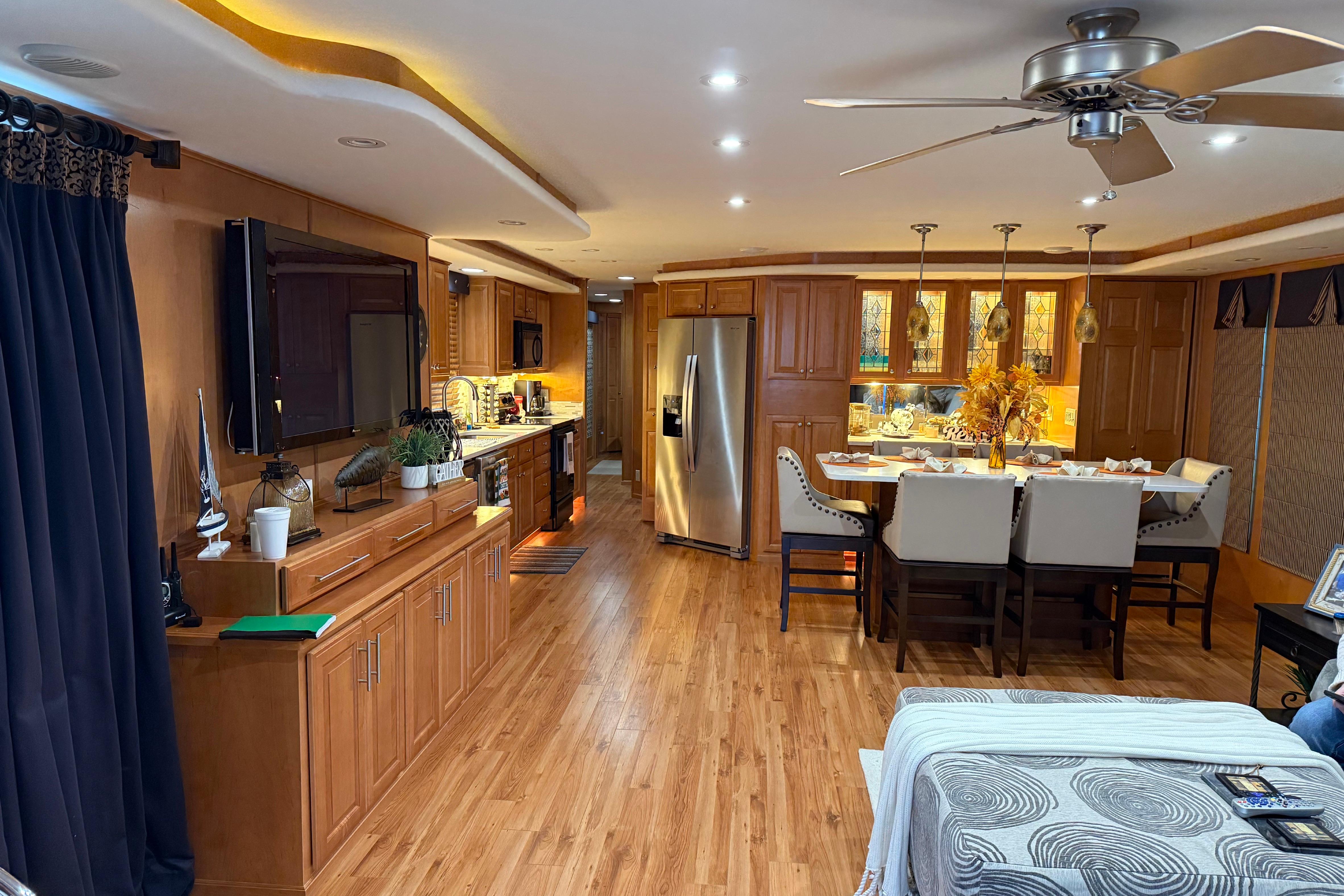 Luxurious interior of a 2001 Sharpe 80 X 18 houseboat with modern kitchen and dining area.