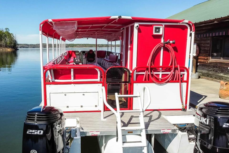 2024 Aloha Pontoon 50' Water Taxi with red canopy and dual Suzuki 250 engines.